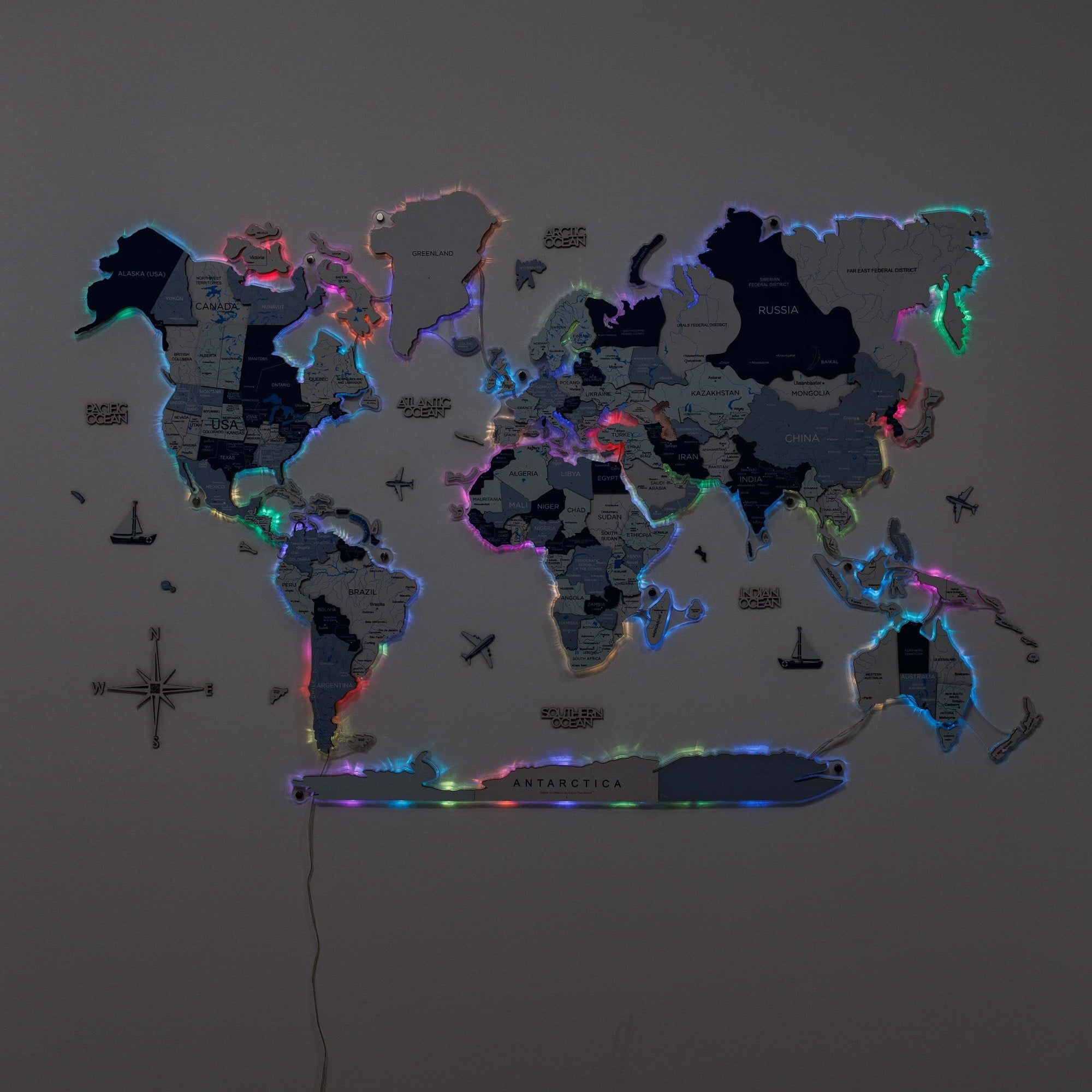 World map with colorful lighting effect on a dark background