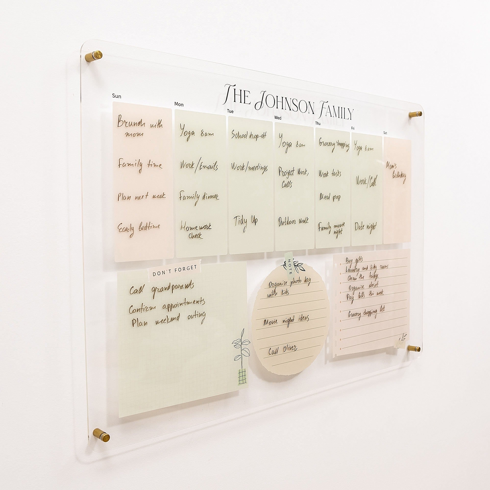 Family chore chart on a white wall with notes and reminders.