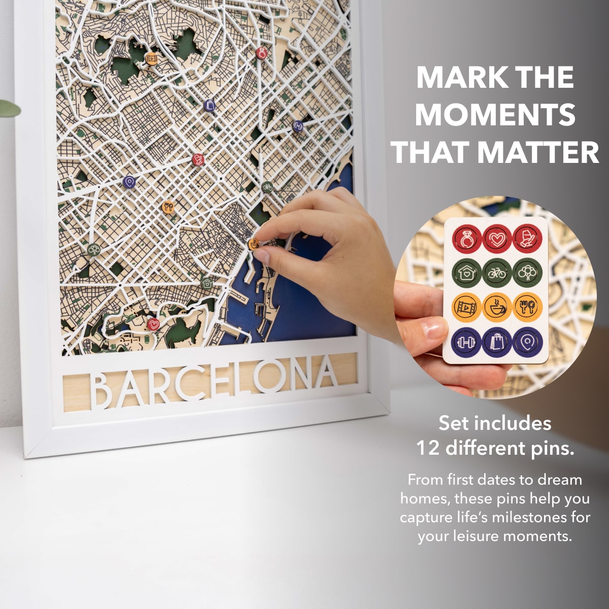 Map of Barcelona with decorative pins and a hand placing a pin, set against a light gray background.
