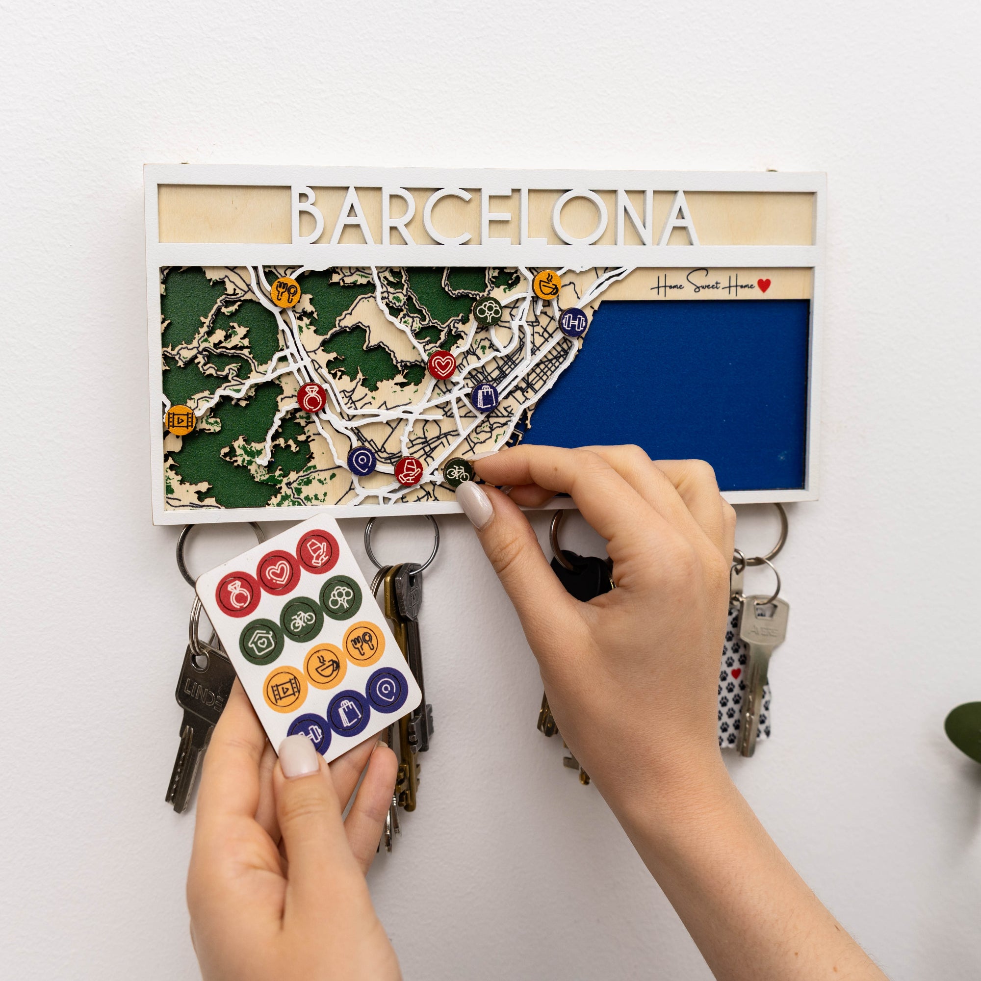 Key holder with a map of Barcelona and keys attached, on a white background