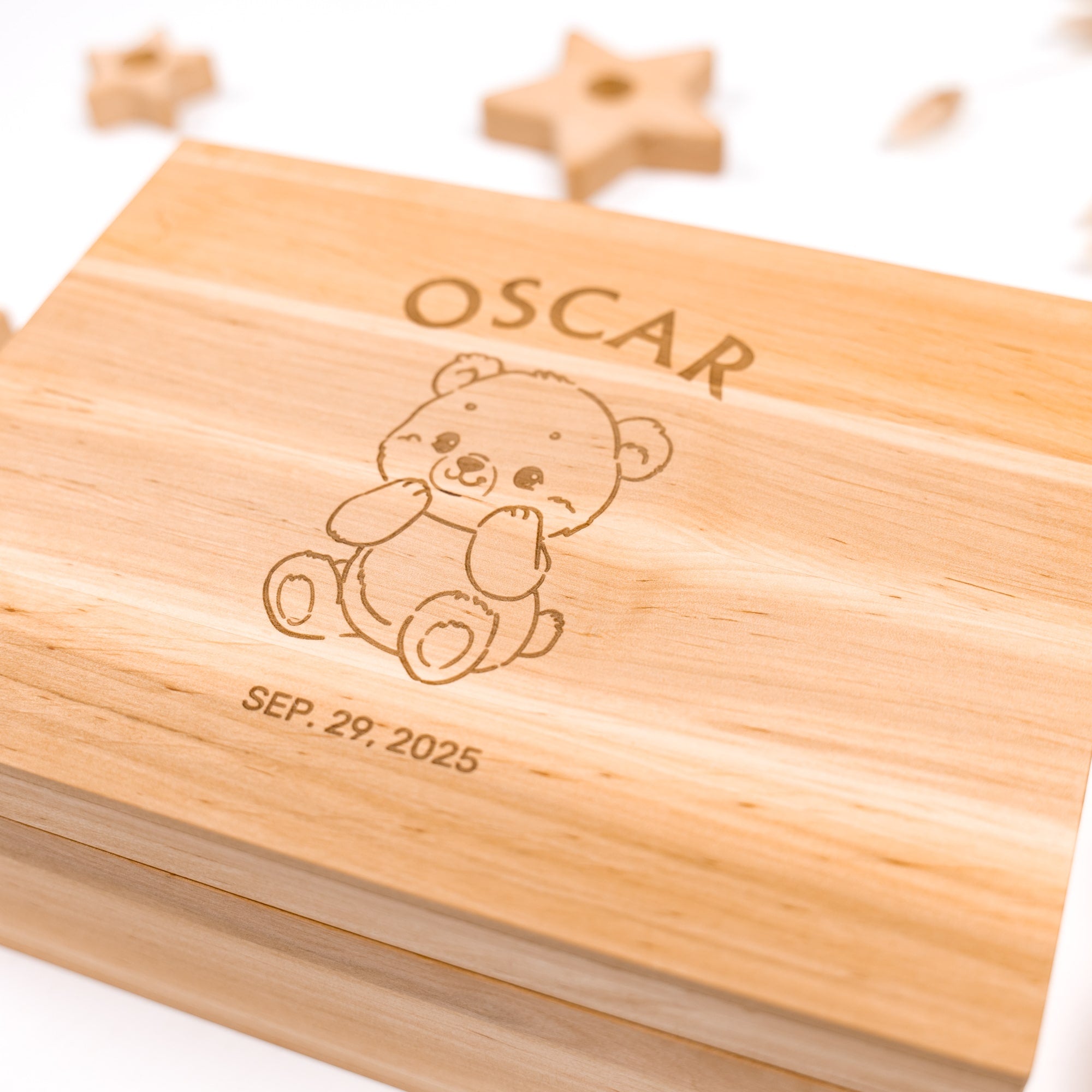 Wooden box with engraved teddy bear and text on a white background