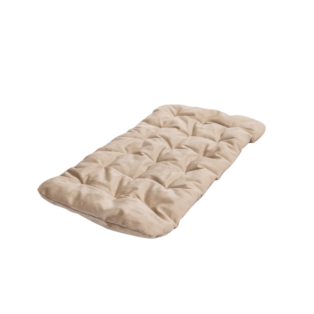 Beige quilted mat on a white surface with a light gray background