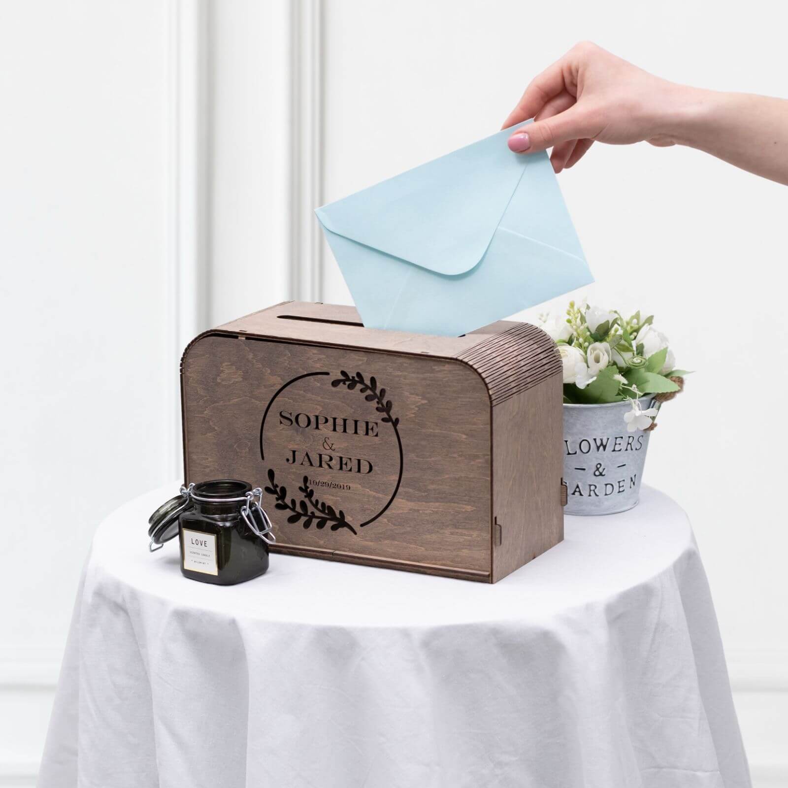 Close-up of engraved wooden card box displaying custom monogram