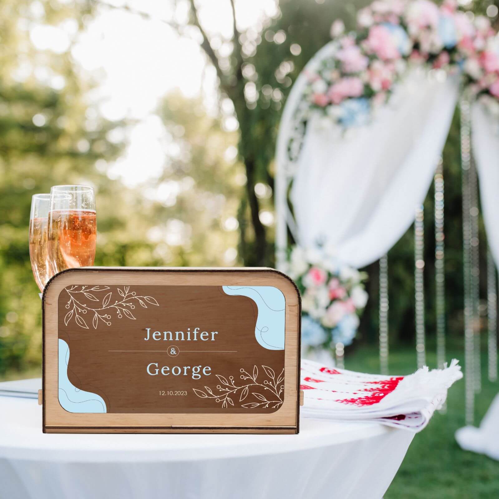 Outdoor wedding card box with elegant floral ceremony backdrop
