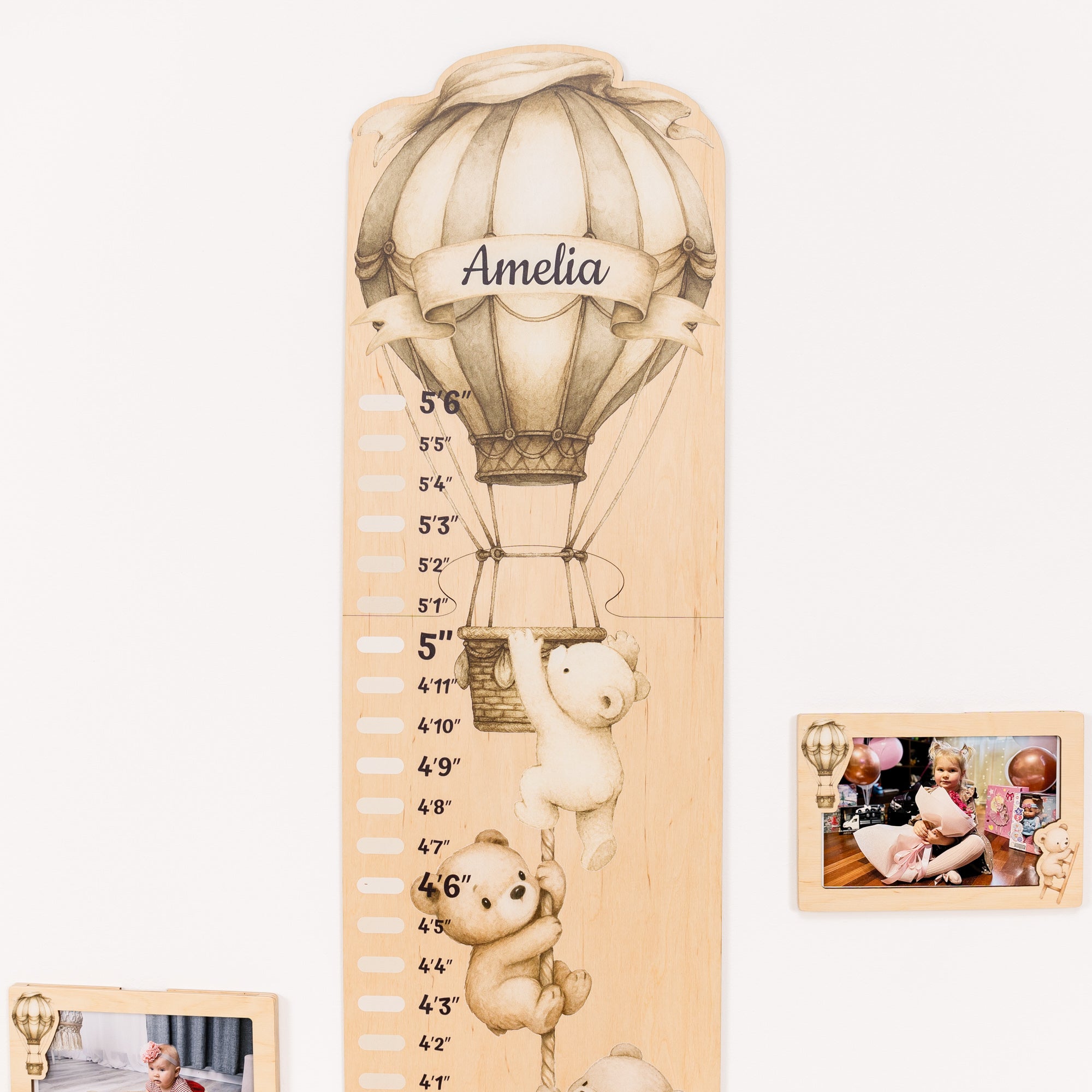 Wooden growth chart with teddy bear design and 'Amelia' on a white background