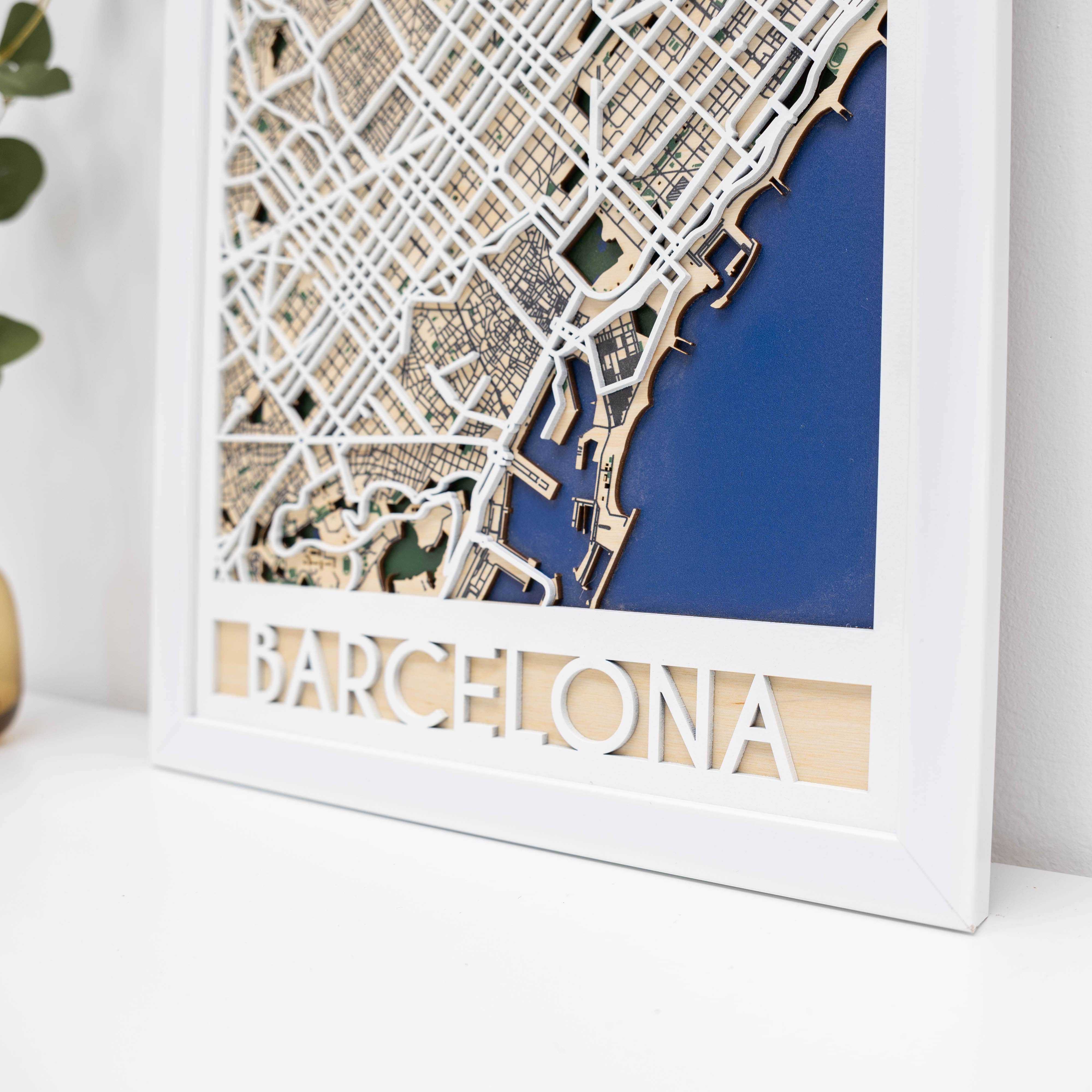 Framed 3D cut-out map of Barcelona with 'Barcelona' text at the bottom.