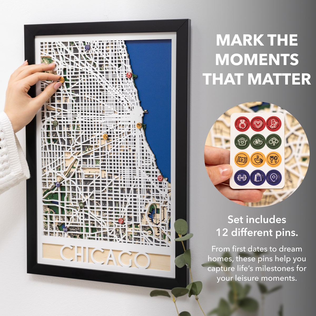Framed map of Chicago with decorative pins and a set of pins on a gray background.