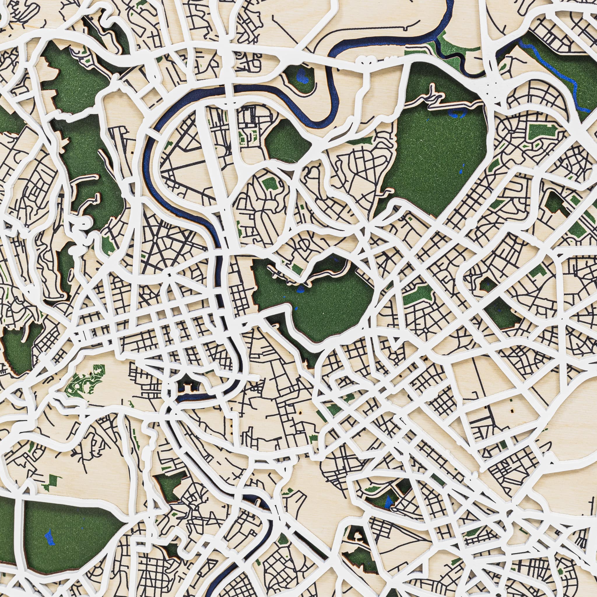 Close-up of a detailed city map with roads and green spaces.