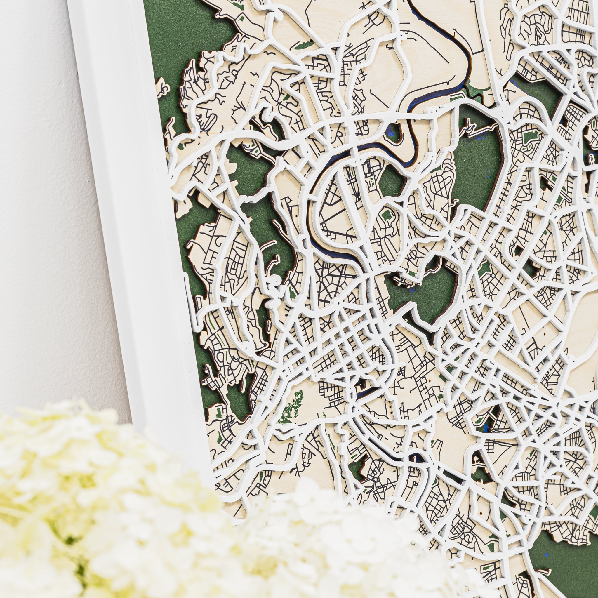 Wooden cutout city map with green and beige colors