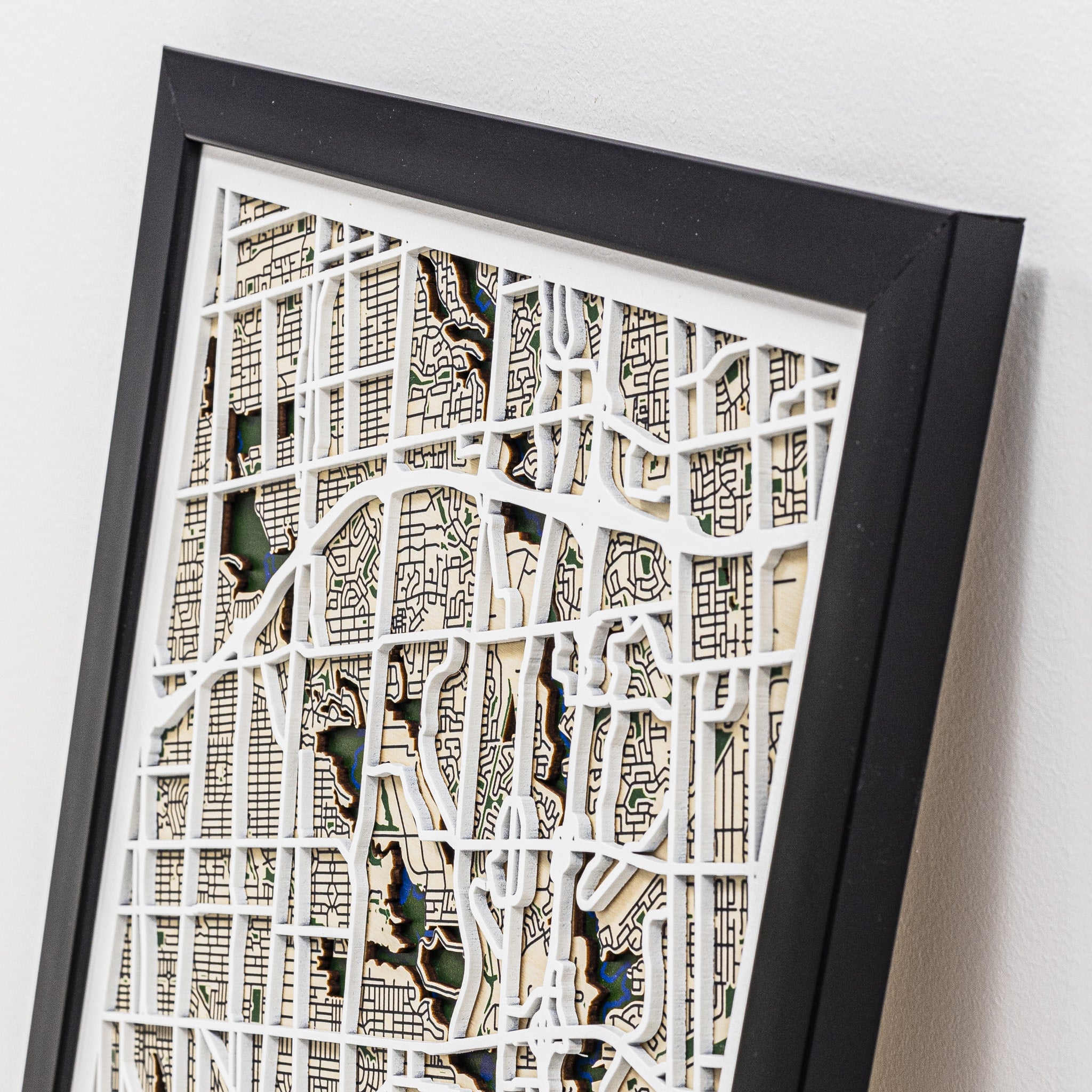 Framed city map art piece on a white background