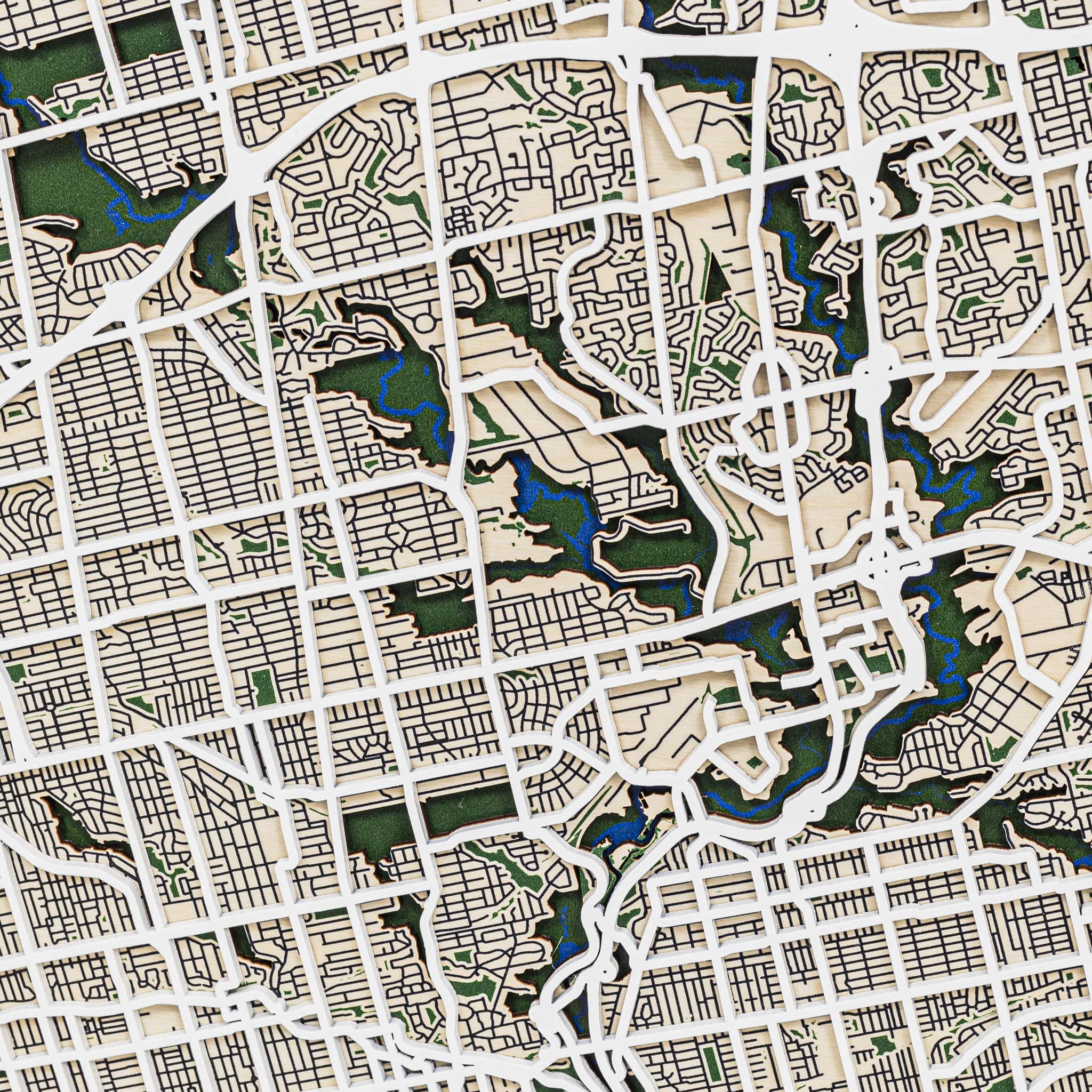 Close-up of a city map with grid lines and green areas