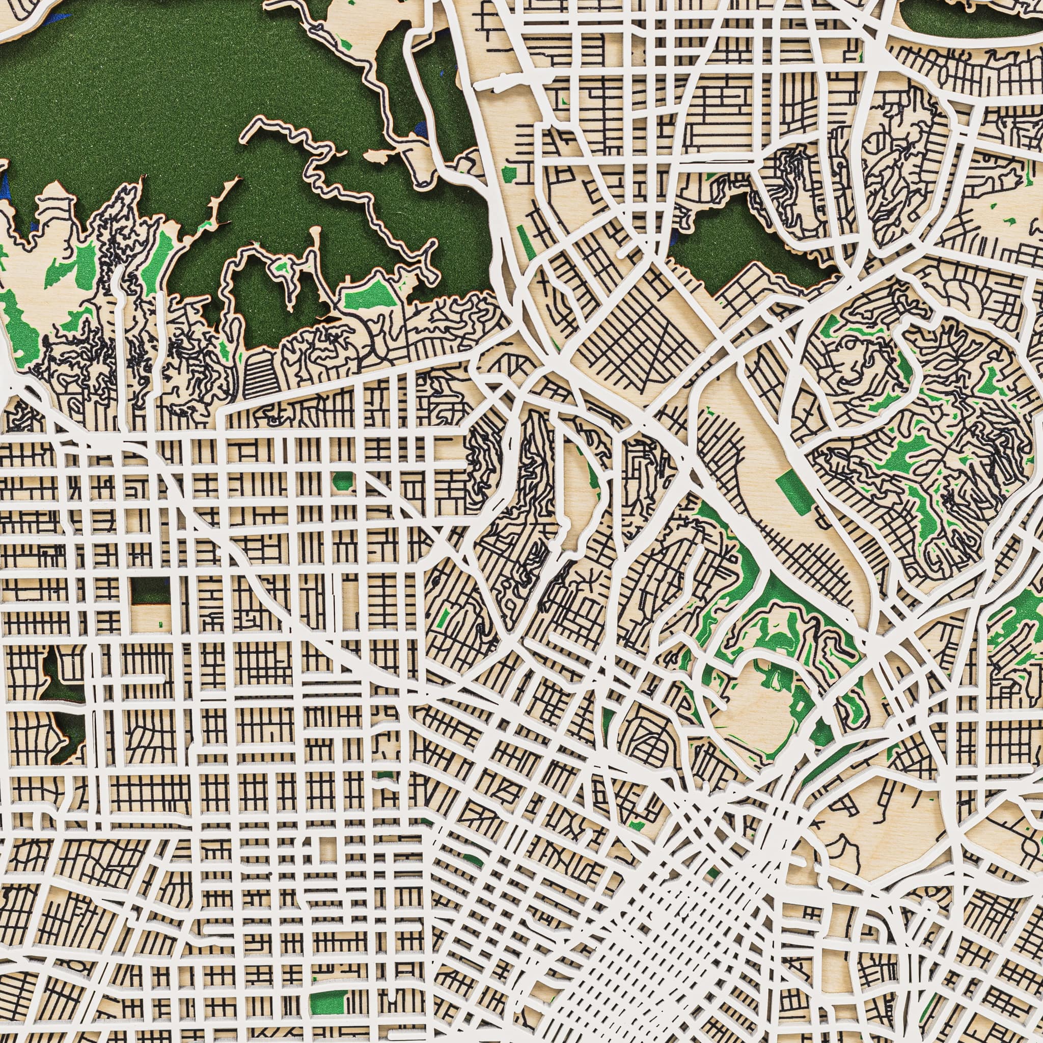 Close-up of a detailed city map with streets and green spaces.