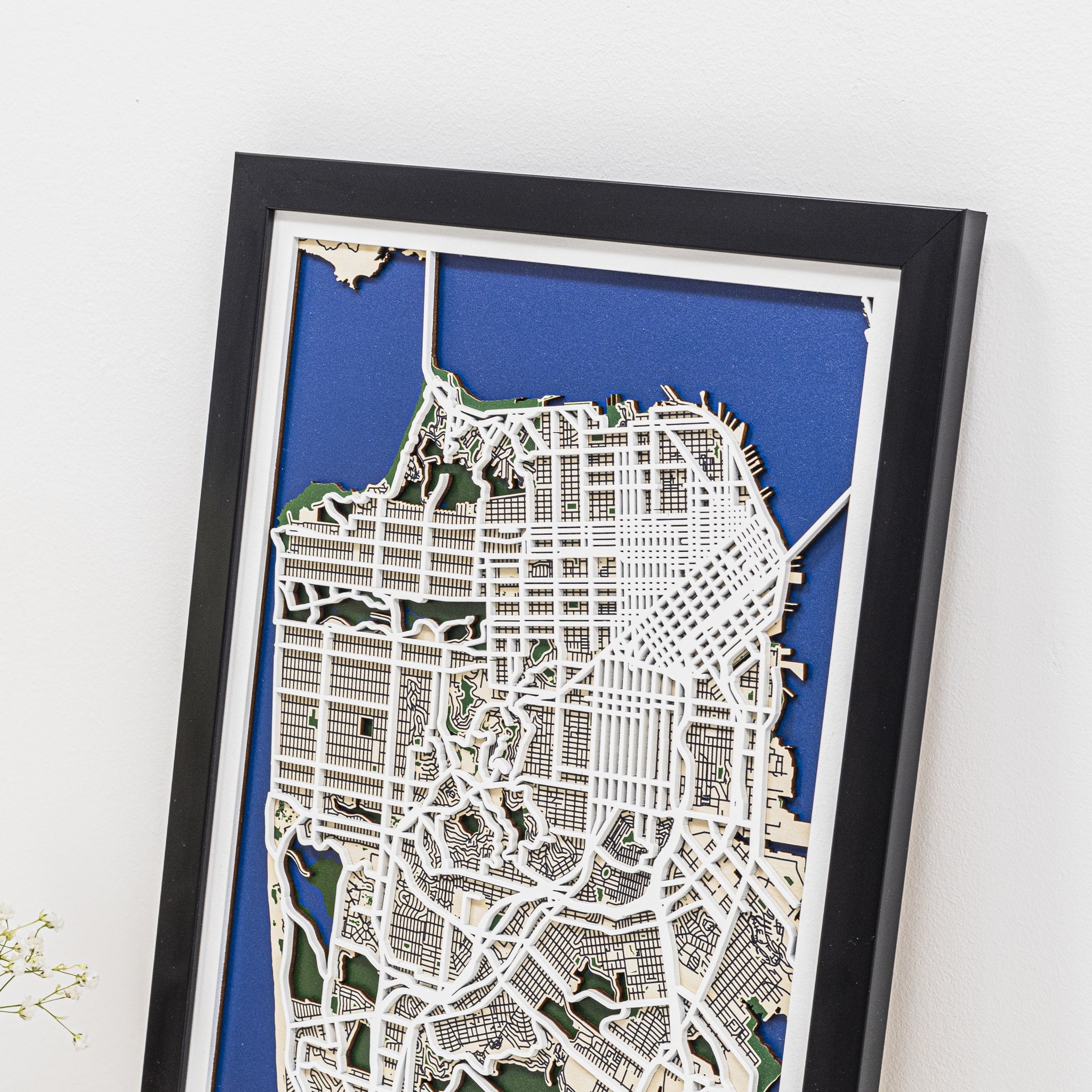 Framed city map on a white wall