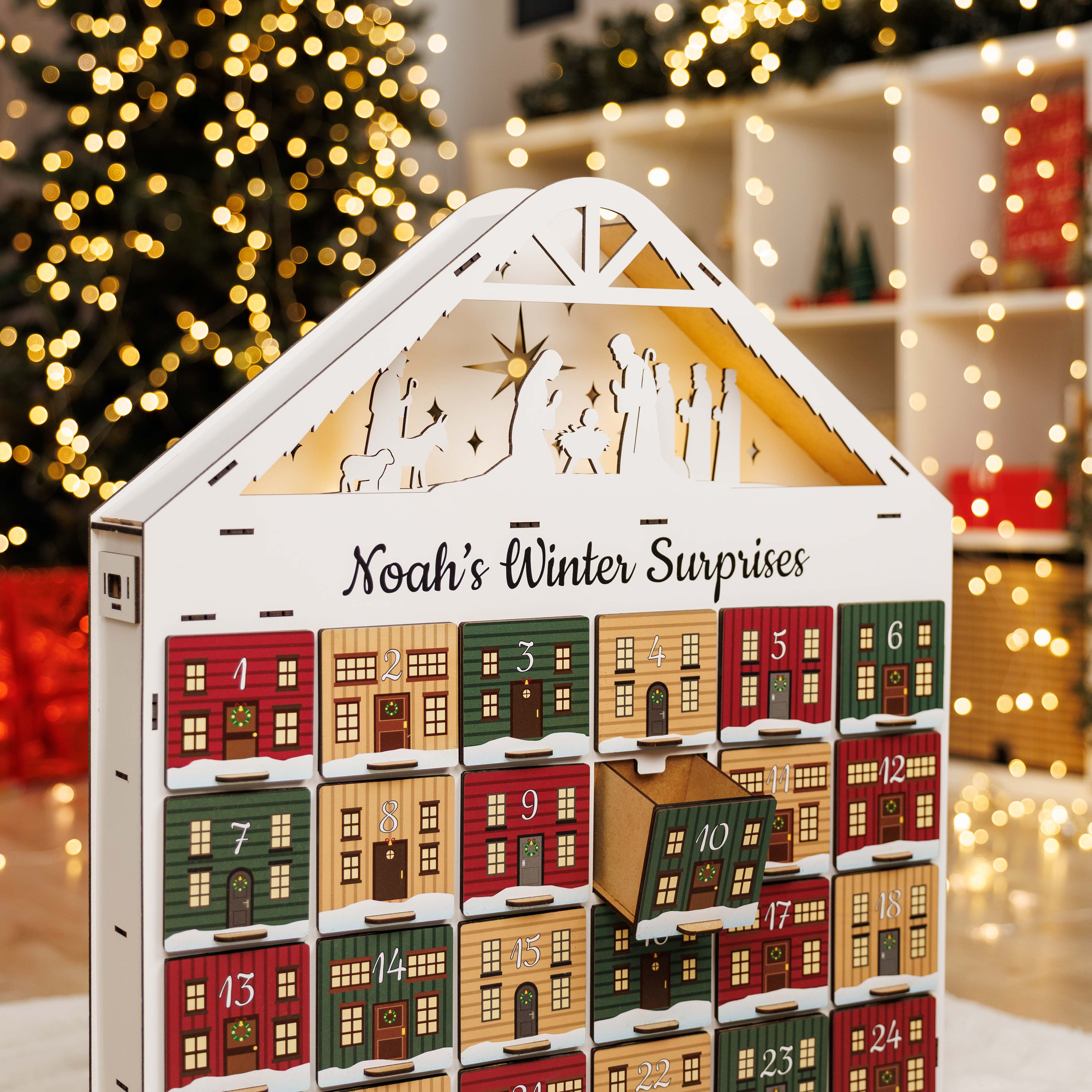 Advent calendar with 'Noah's Winter Surprises' in front of a Christmas tree.