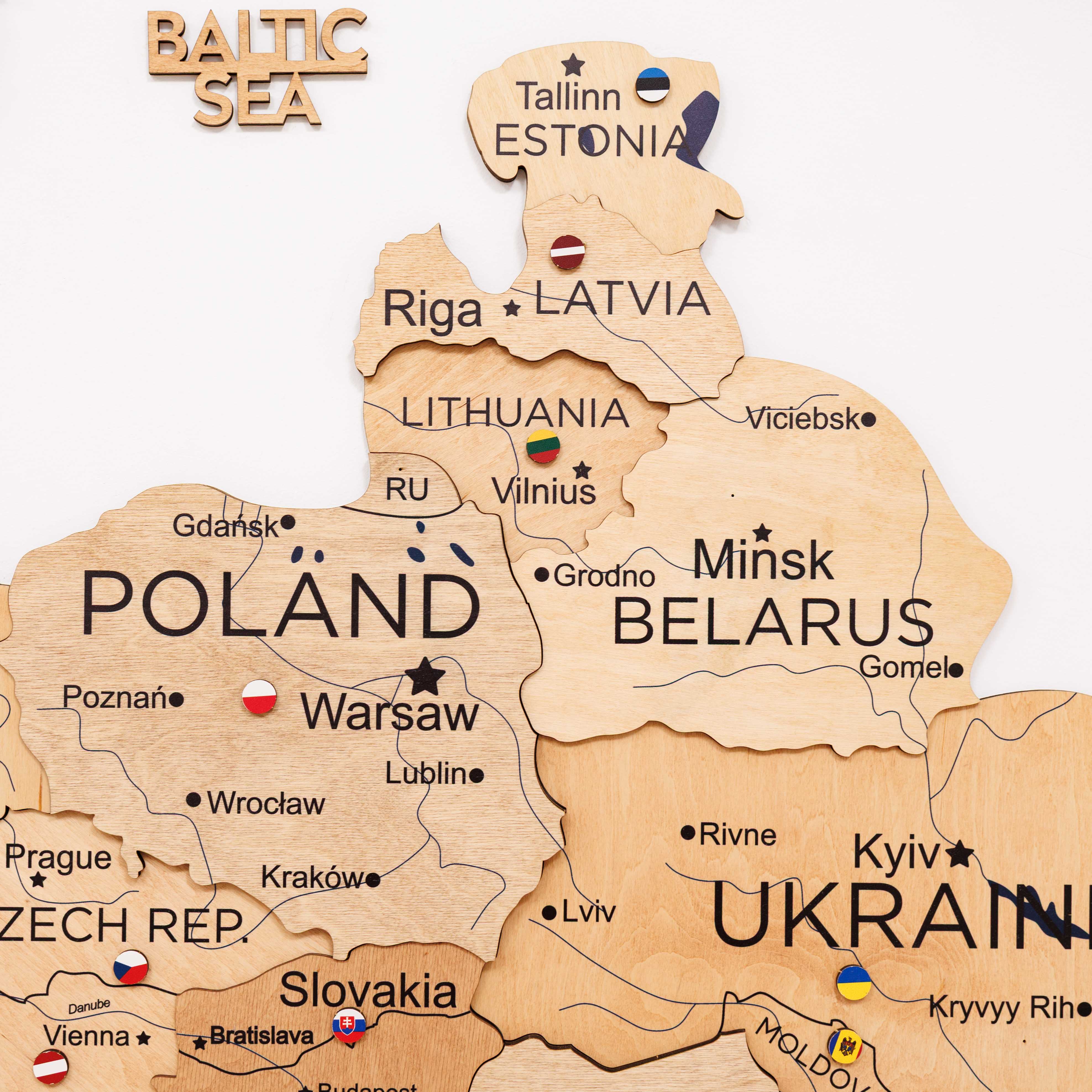 Wooden map of Eastern Europe with country names and flags.