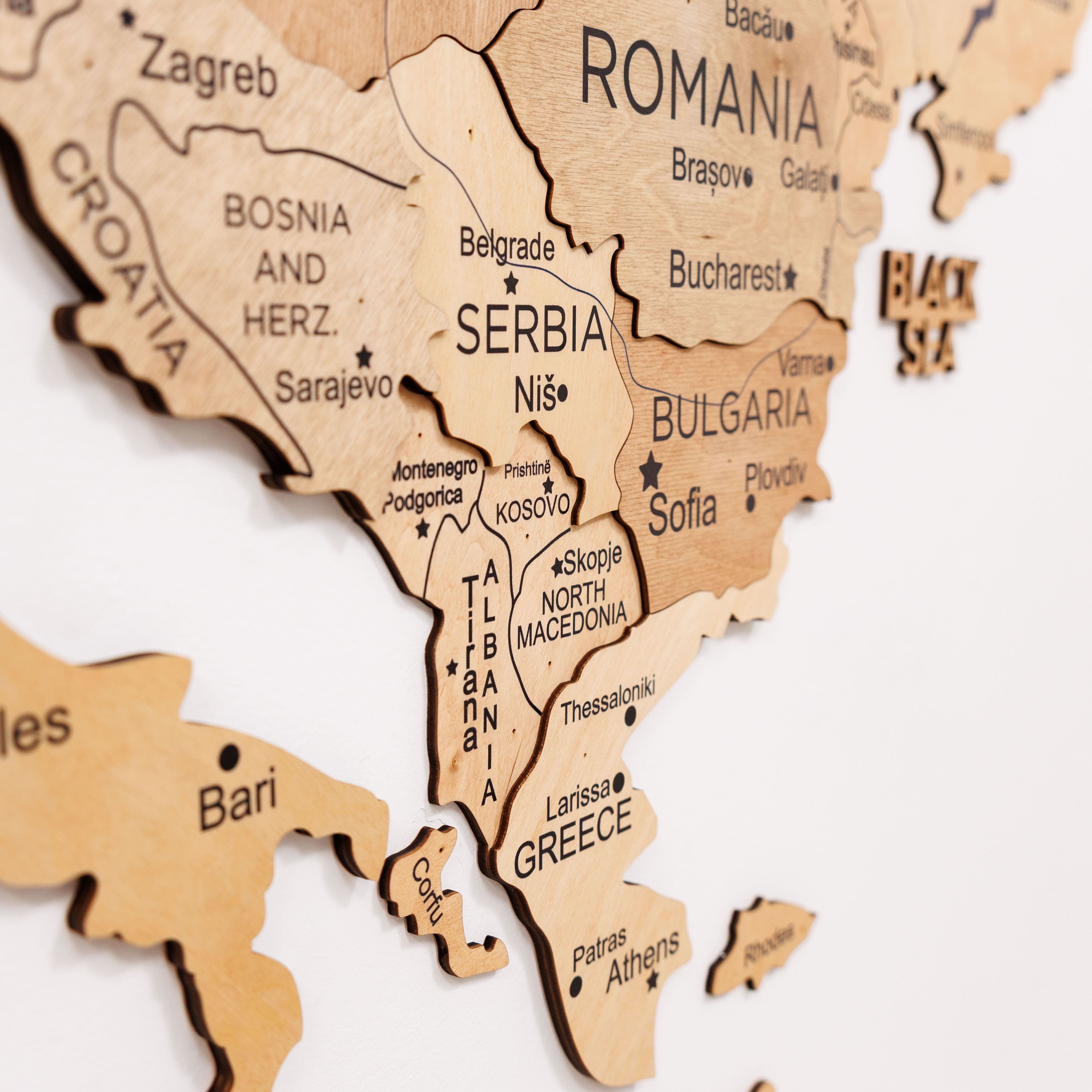 Wooden map of Europe with countries labeled on a white background