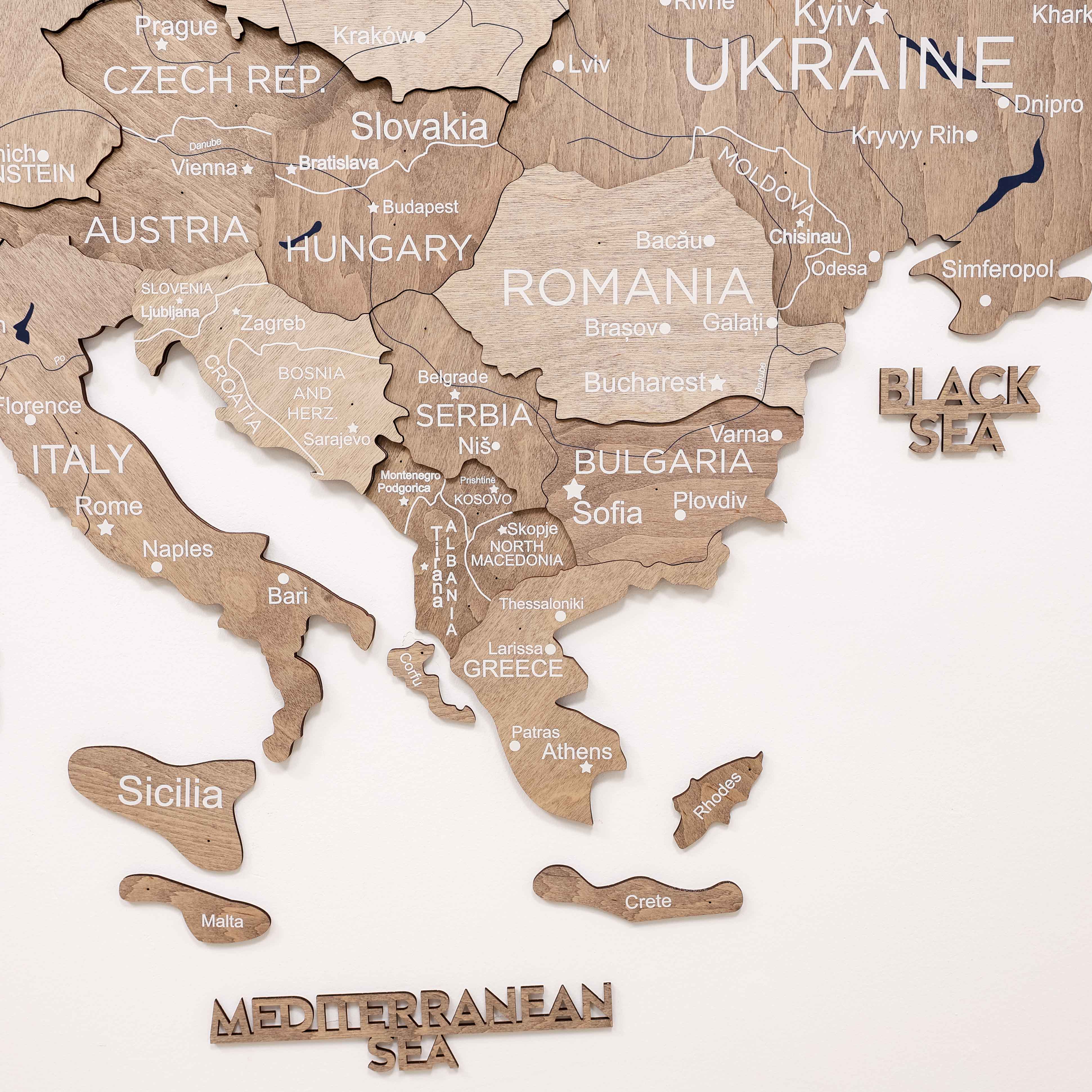 Wooden map of Europe with countries labeled on a white background