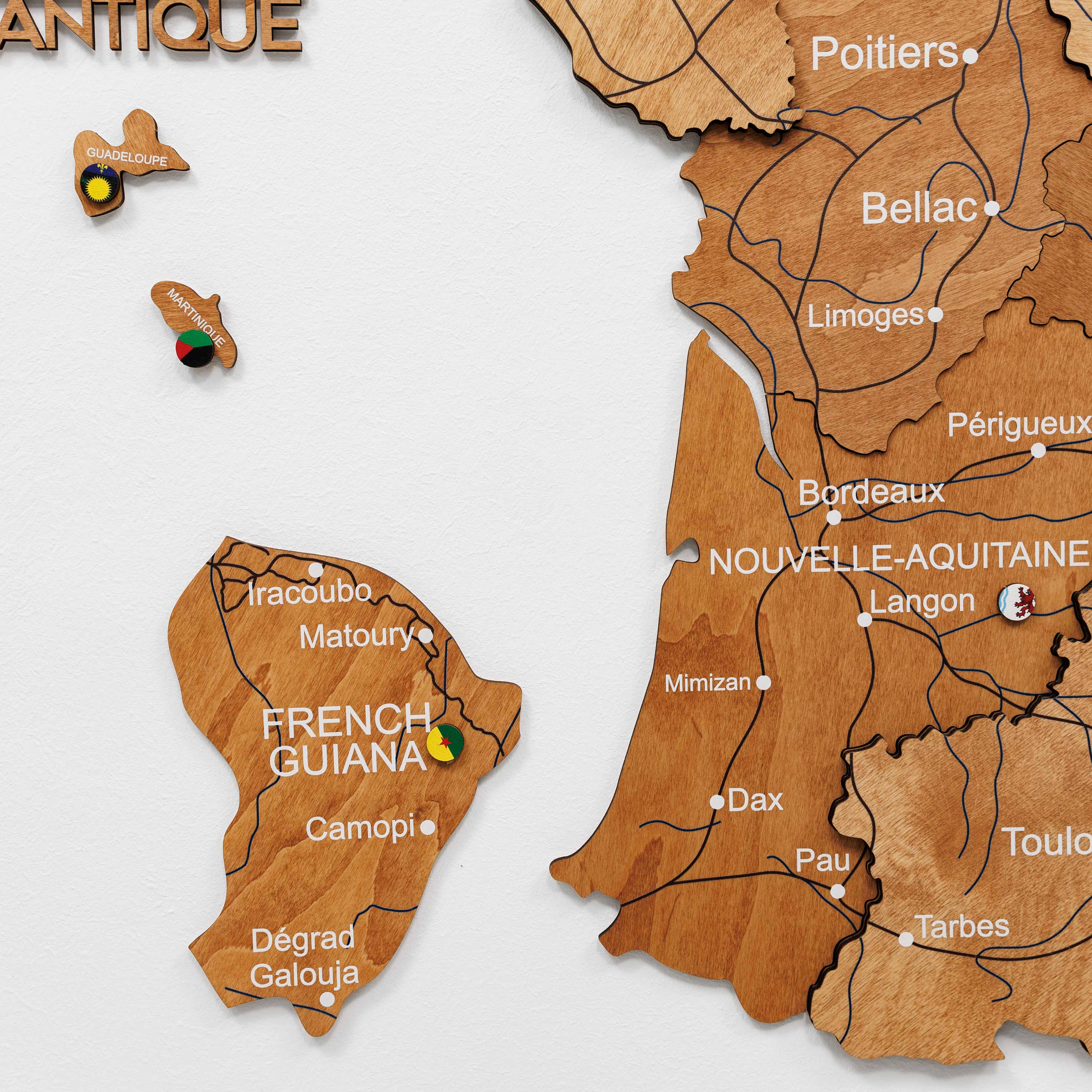 Wooden map of French Guiana and Nouvelle-Aquitaine with cities labeled on a white background.