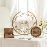 Decorative wooden signs on a table with floral arrangements and a white curtain background