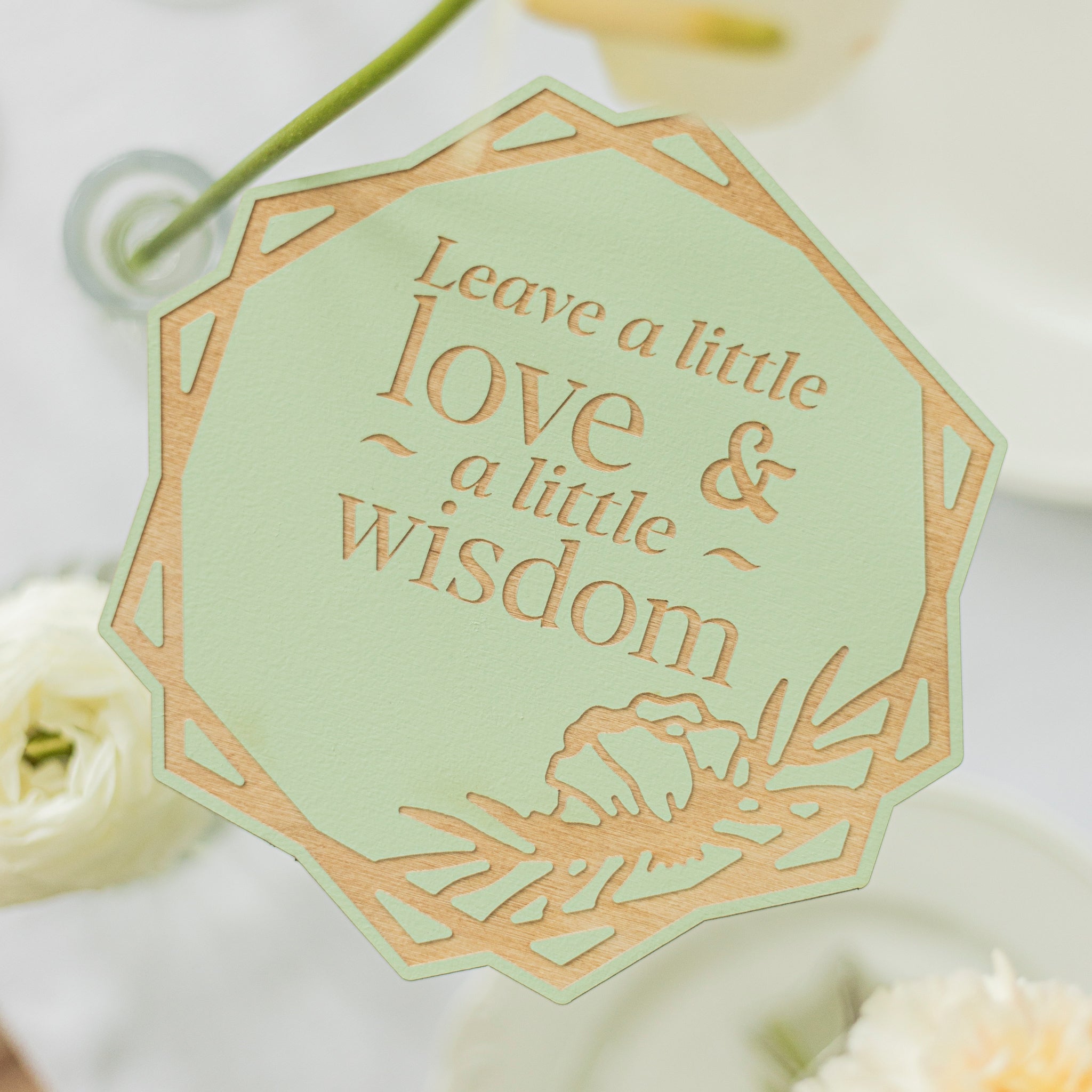 Decorative tag with 'Leave a little love & a little wisdom' text on a light green background.