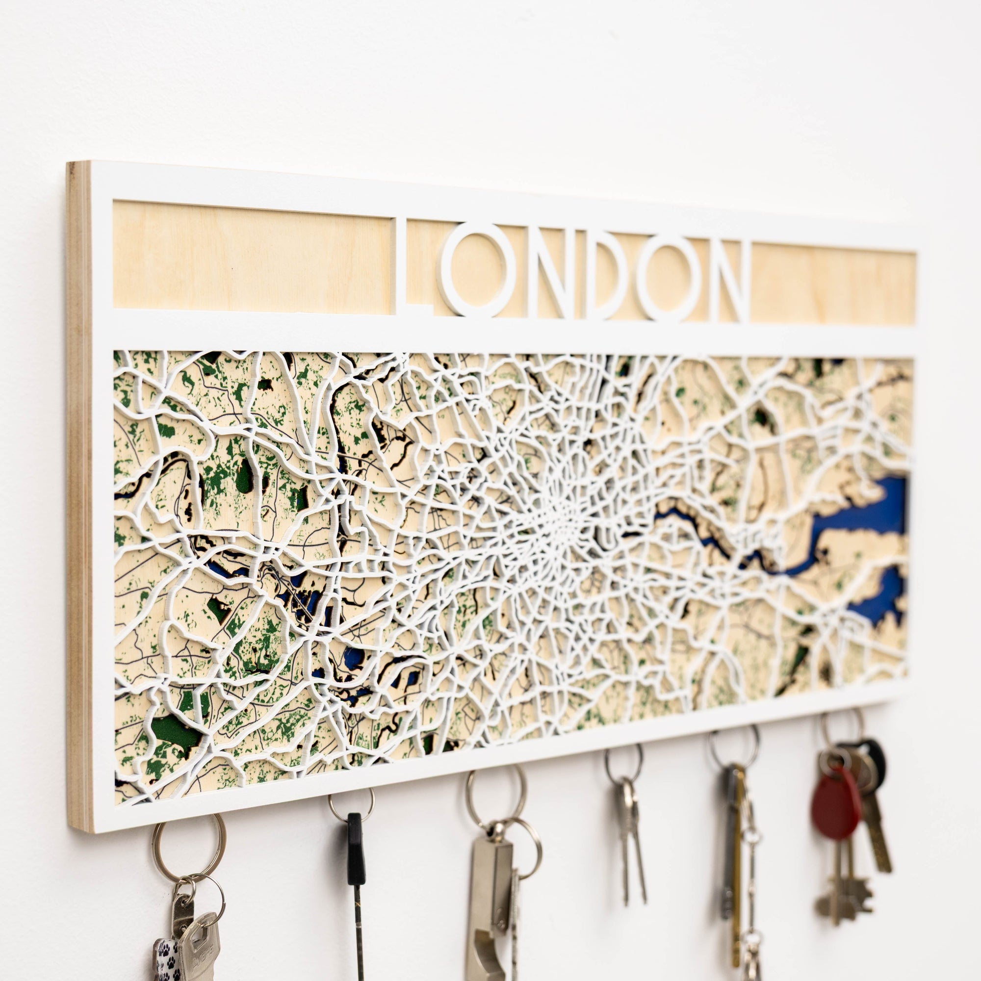 Key holder with a map design of London on a white wall