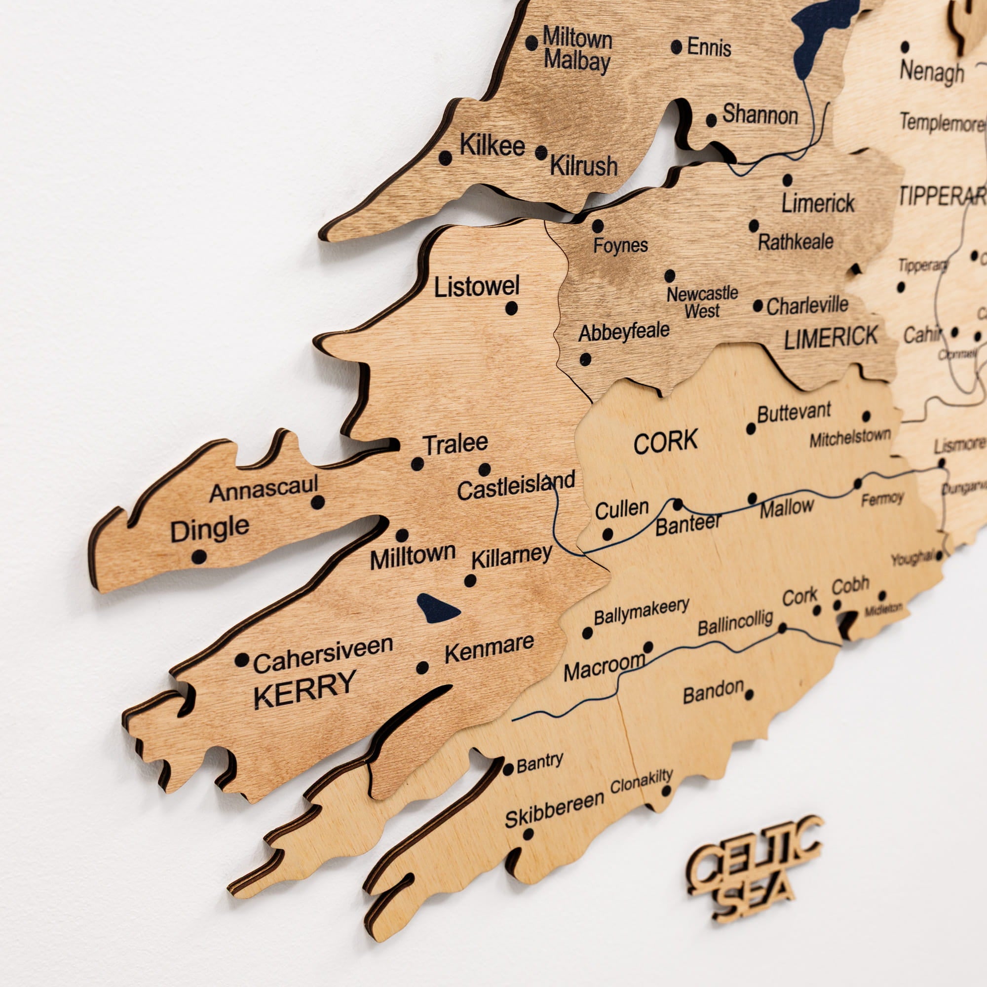 Wooden map of Ireland with counties cut out, featuring 'Celtic Sea' branding.