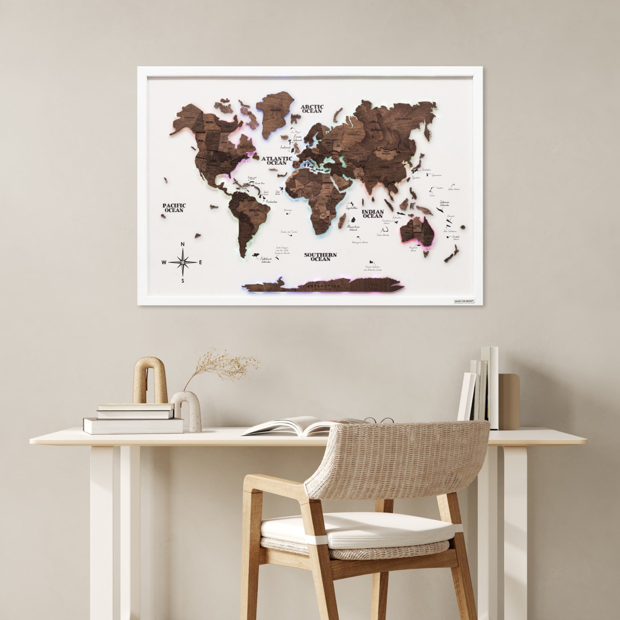 World map poster on a wall above a desk with a chair.