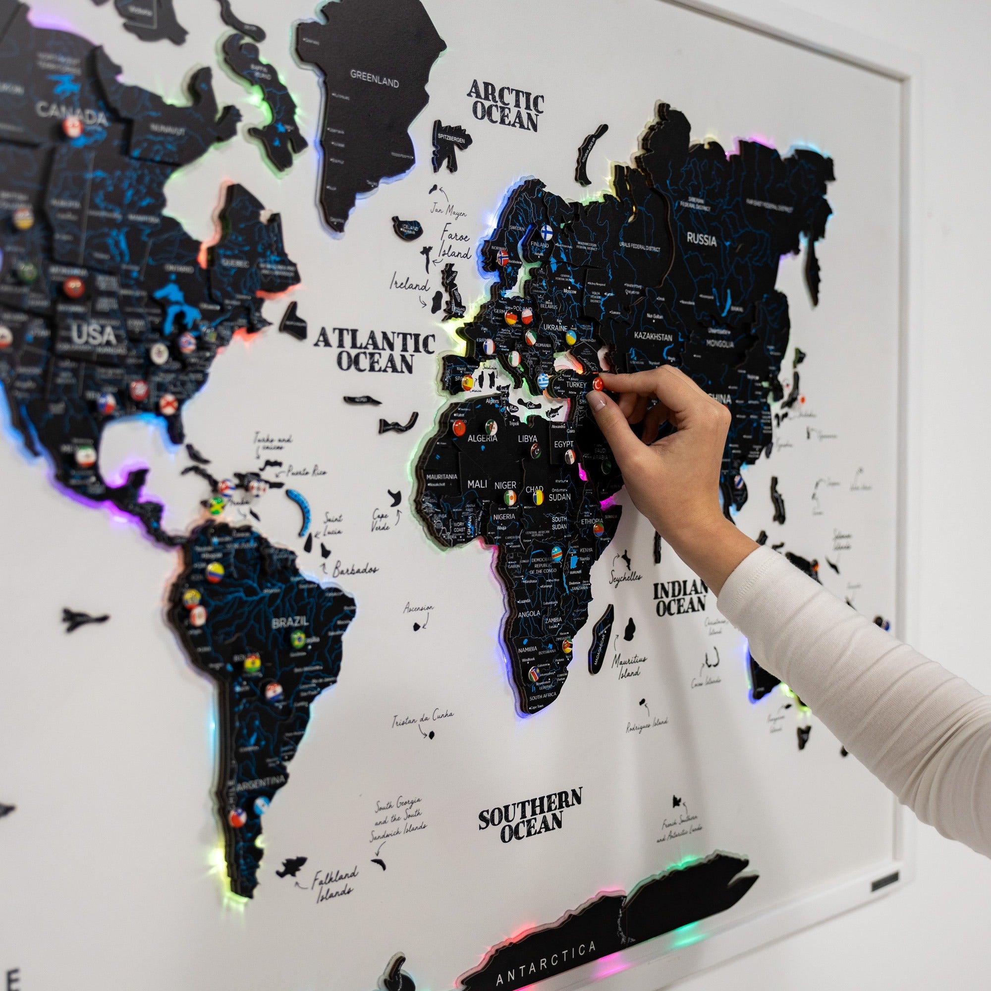 World map with LED lights being interacted with by a hand