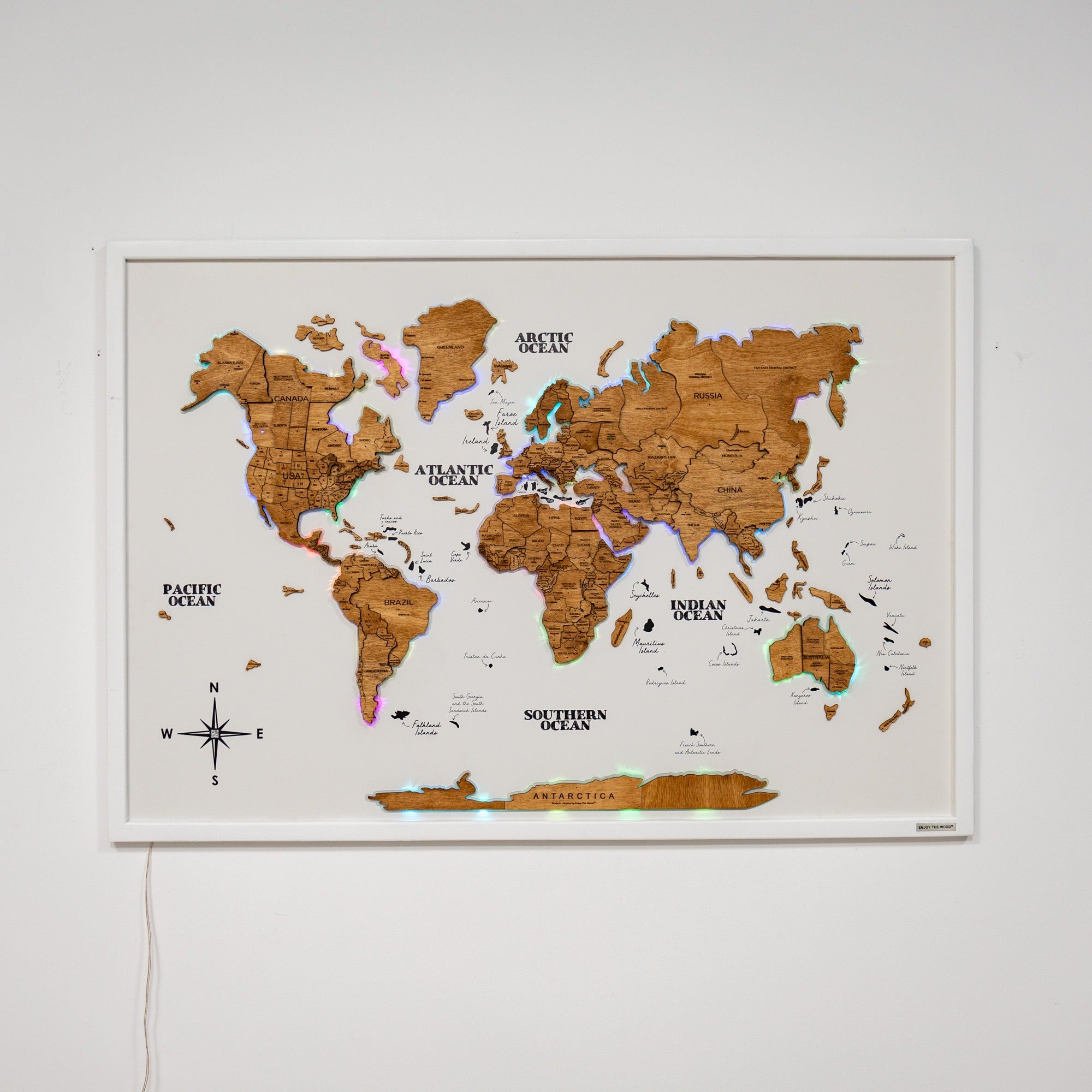 Wooden world map on a white wall