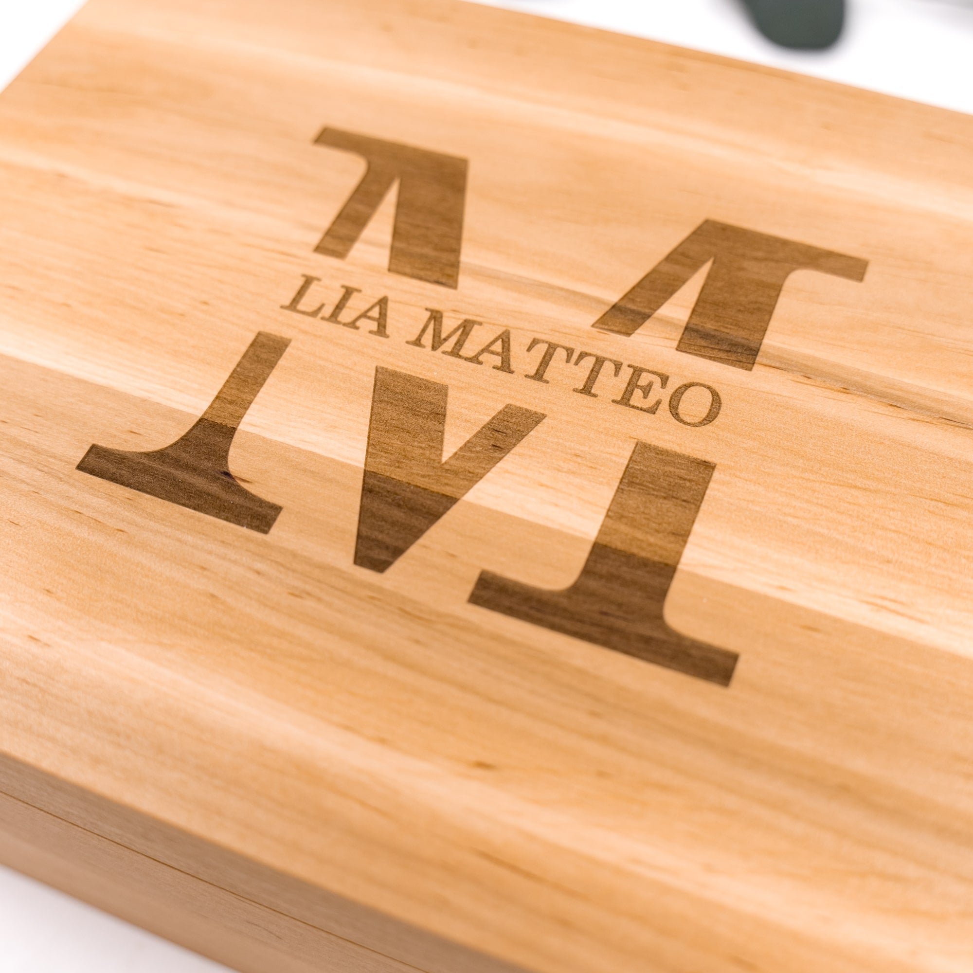 Wooden cutting board with engraved text on a white background