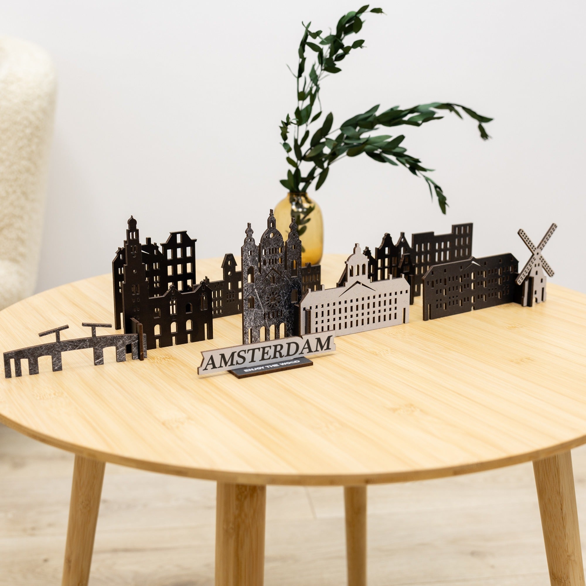 Model of Amsterdam skyline on a wooden table with a plant in the background