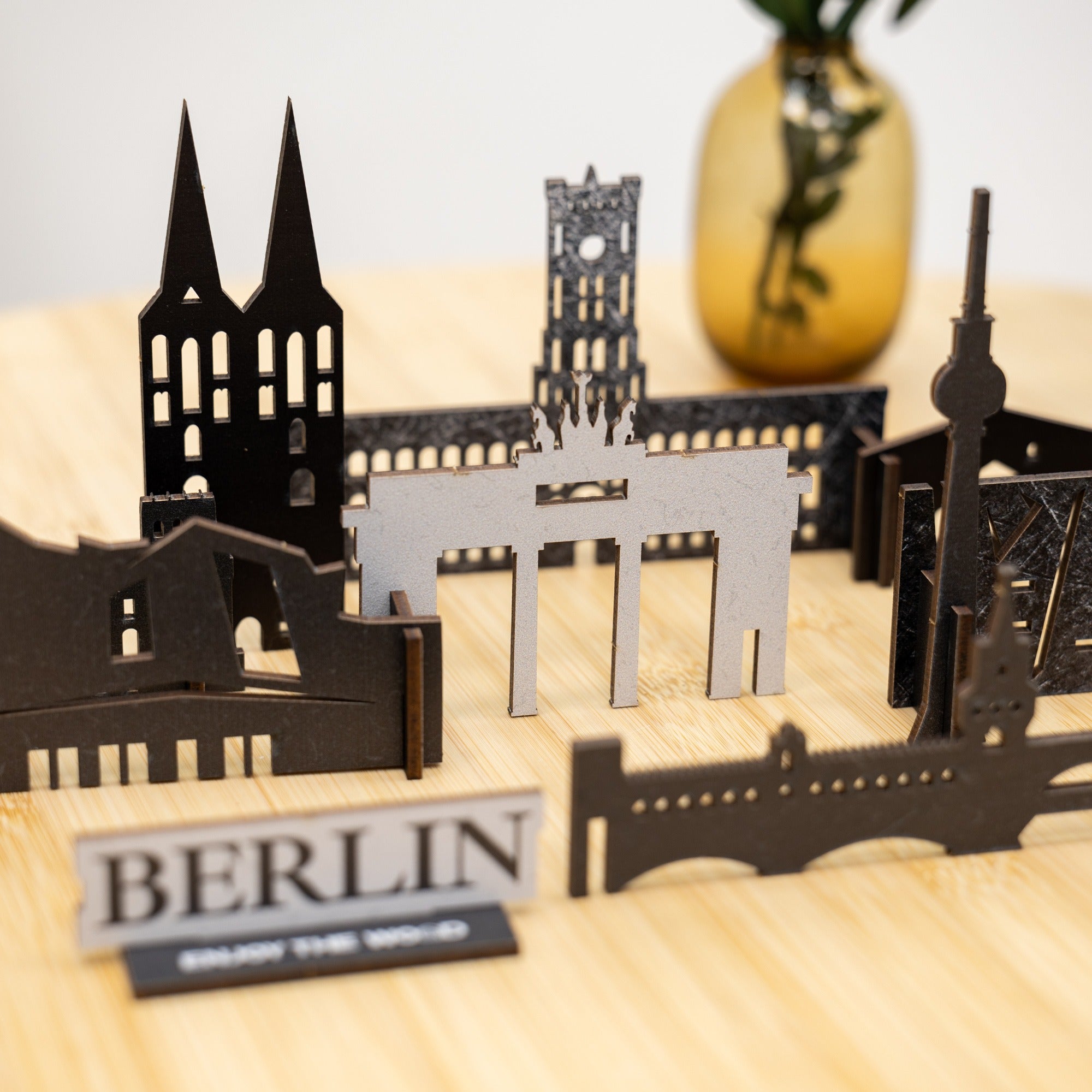 Model of Berlin landmarks on a wooden surface with 'BERLIN' sign.
