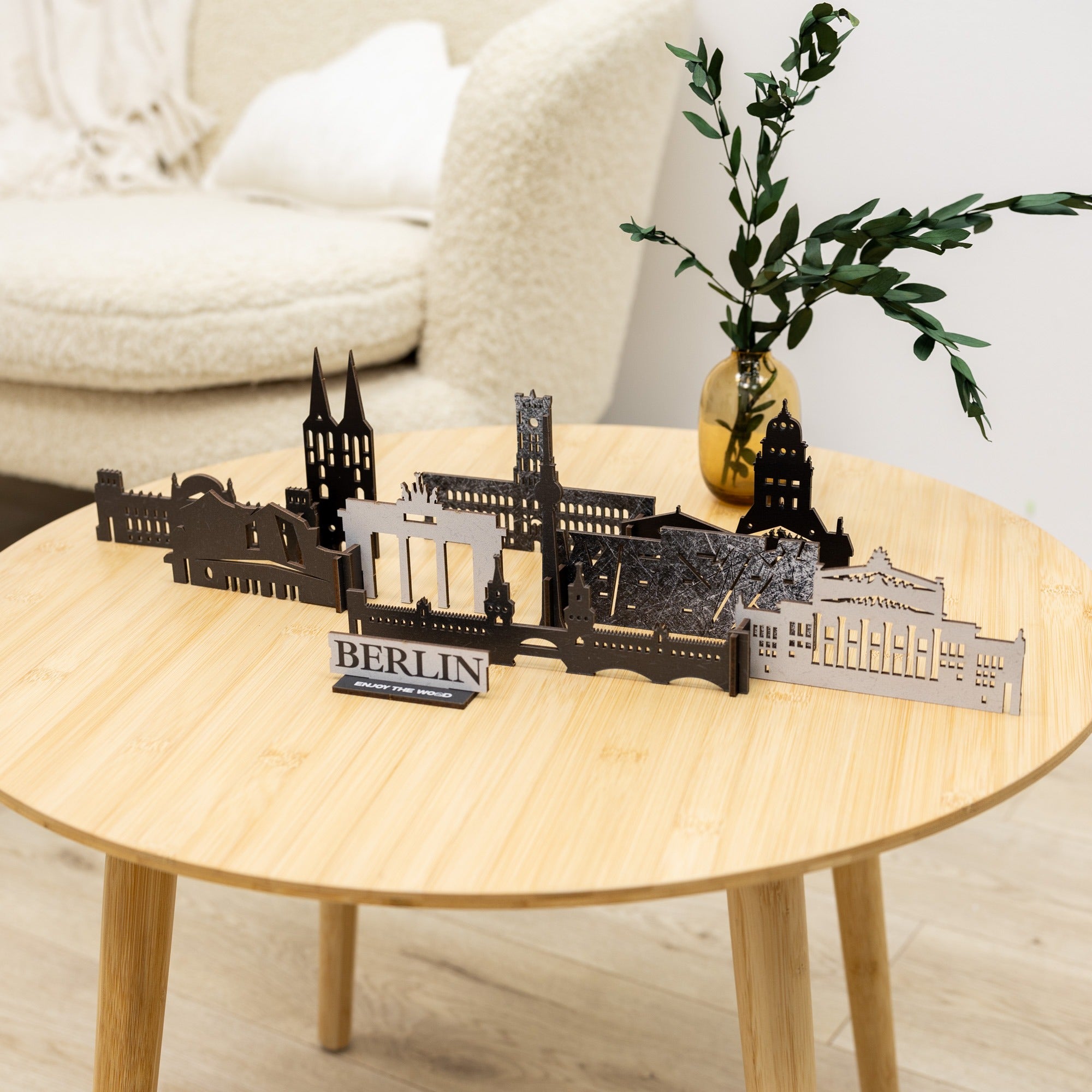 Model of Berlin landmarks on a wooden table with a plant in the background