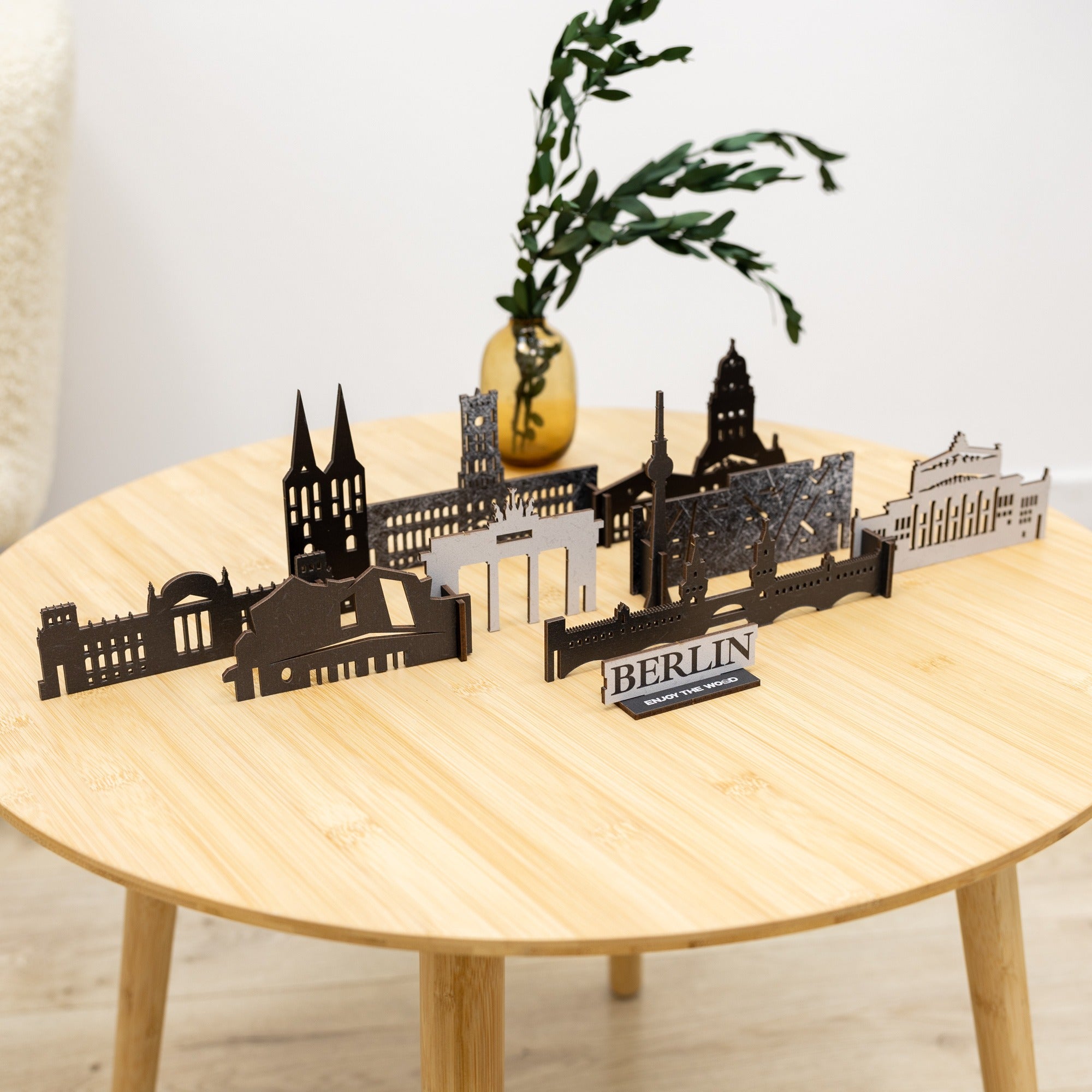 Model of Berlin landmarks on a wooden table with a plant in the background