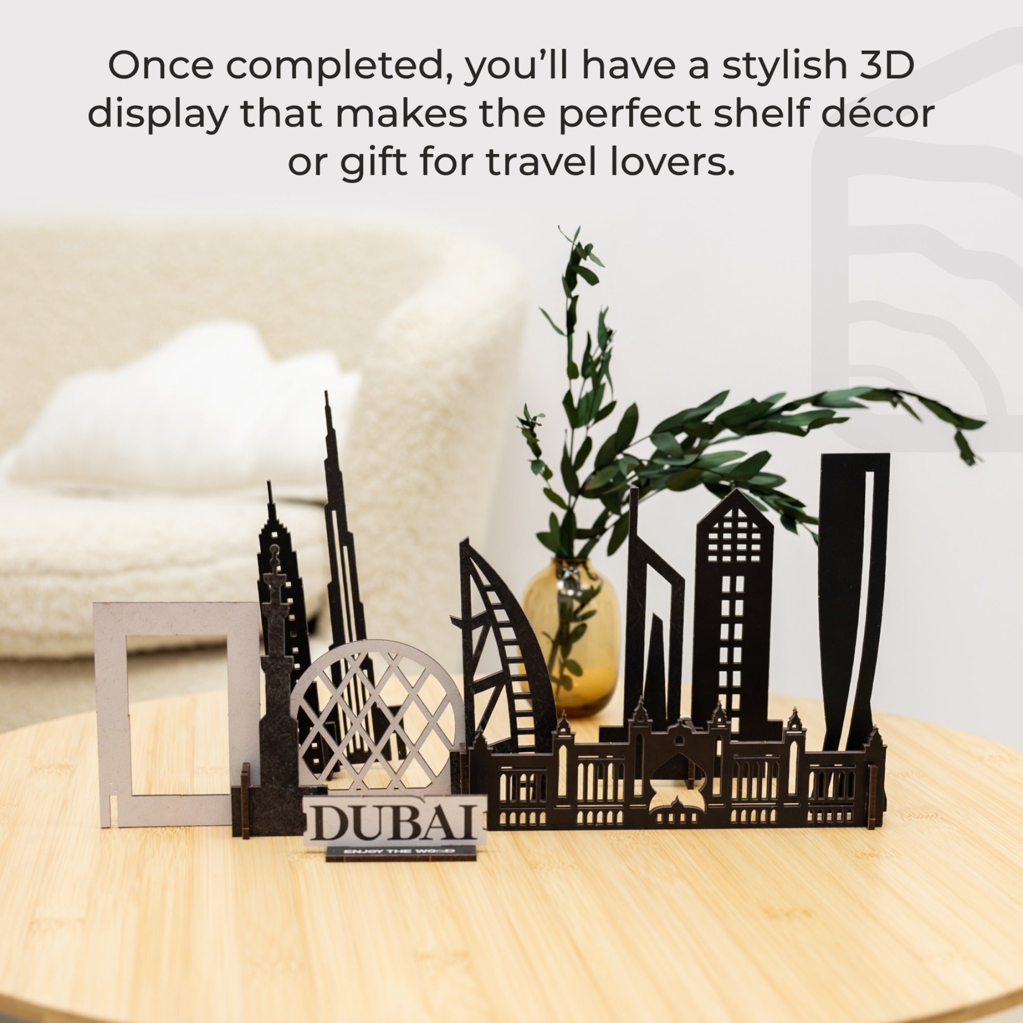 3D metal cityscape model with 'Dubai' branding on a wooden surface.