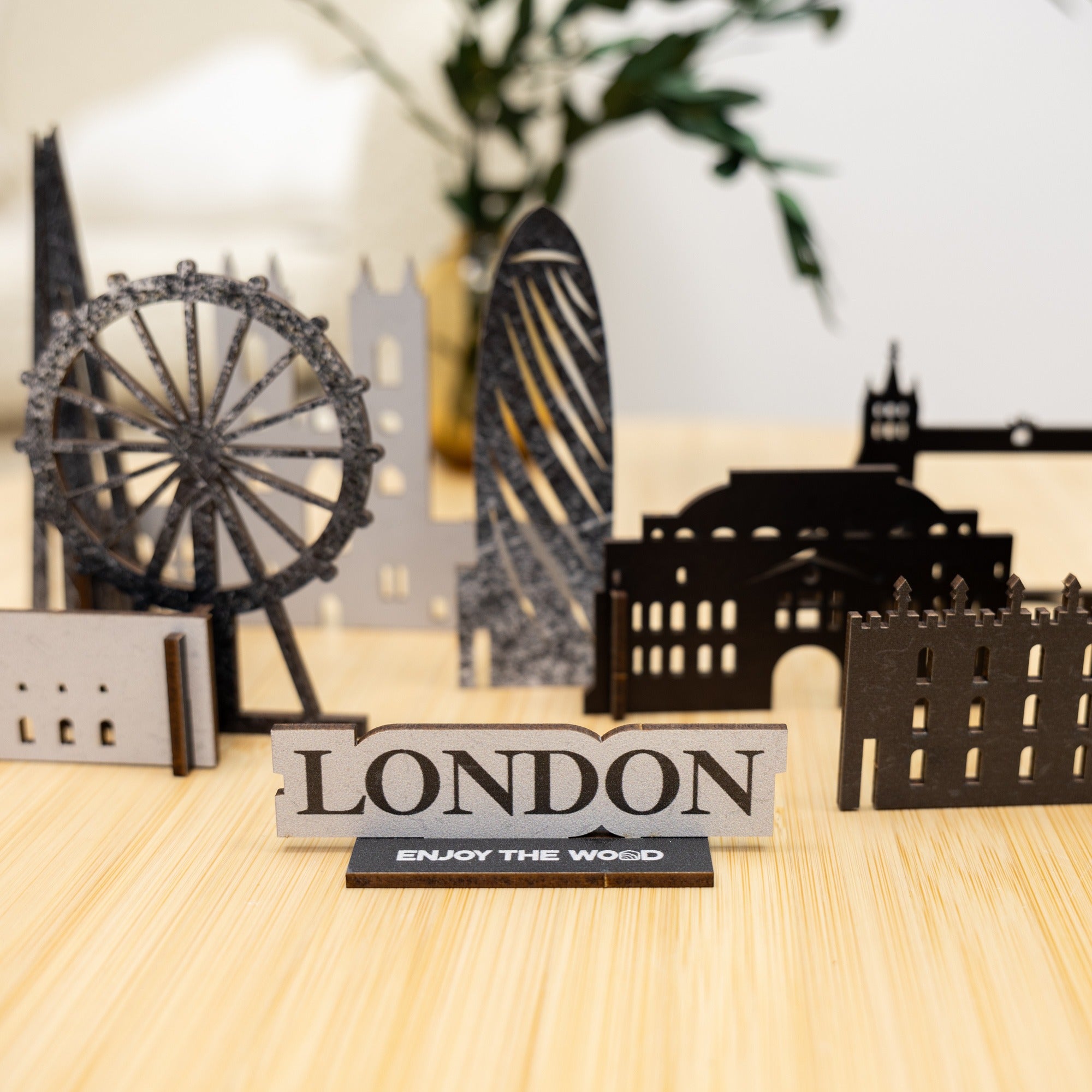 Metallic London-themed decorative set on a wooden surface with blurred background