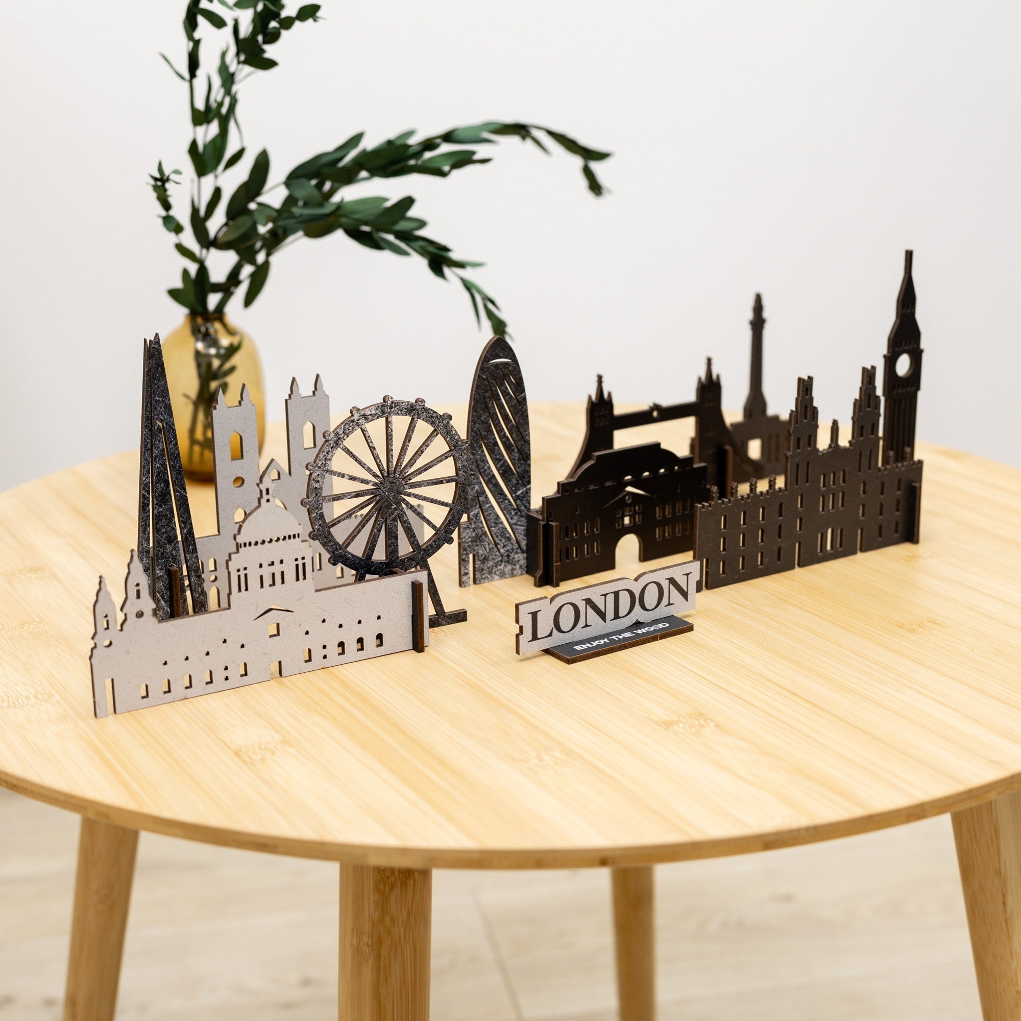Model of London skyline on a wooden table with a plant in the background