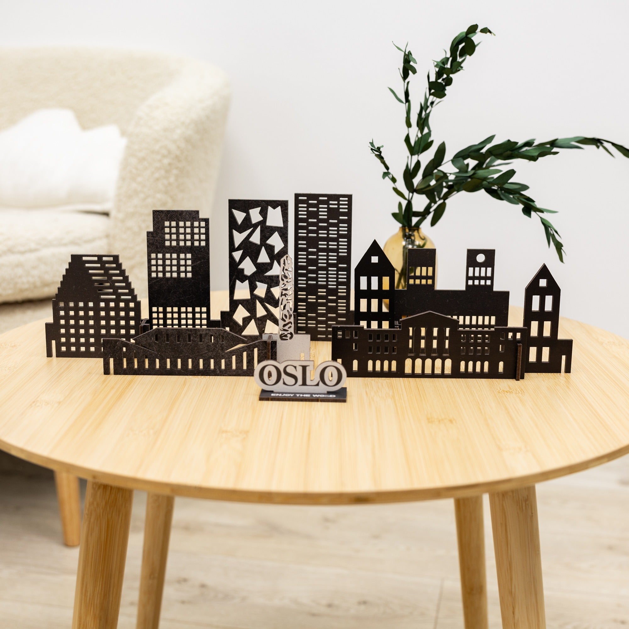 Decorative cityscape sculpture with 'Oslo' on a wooden table