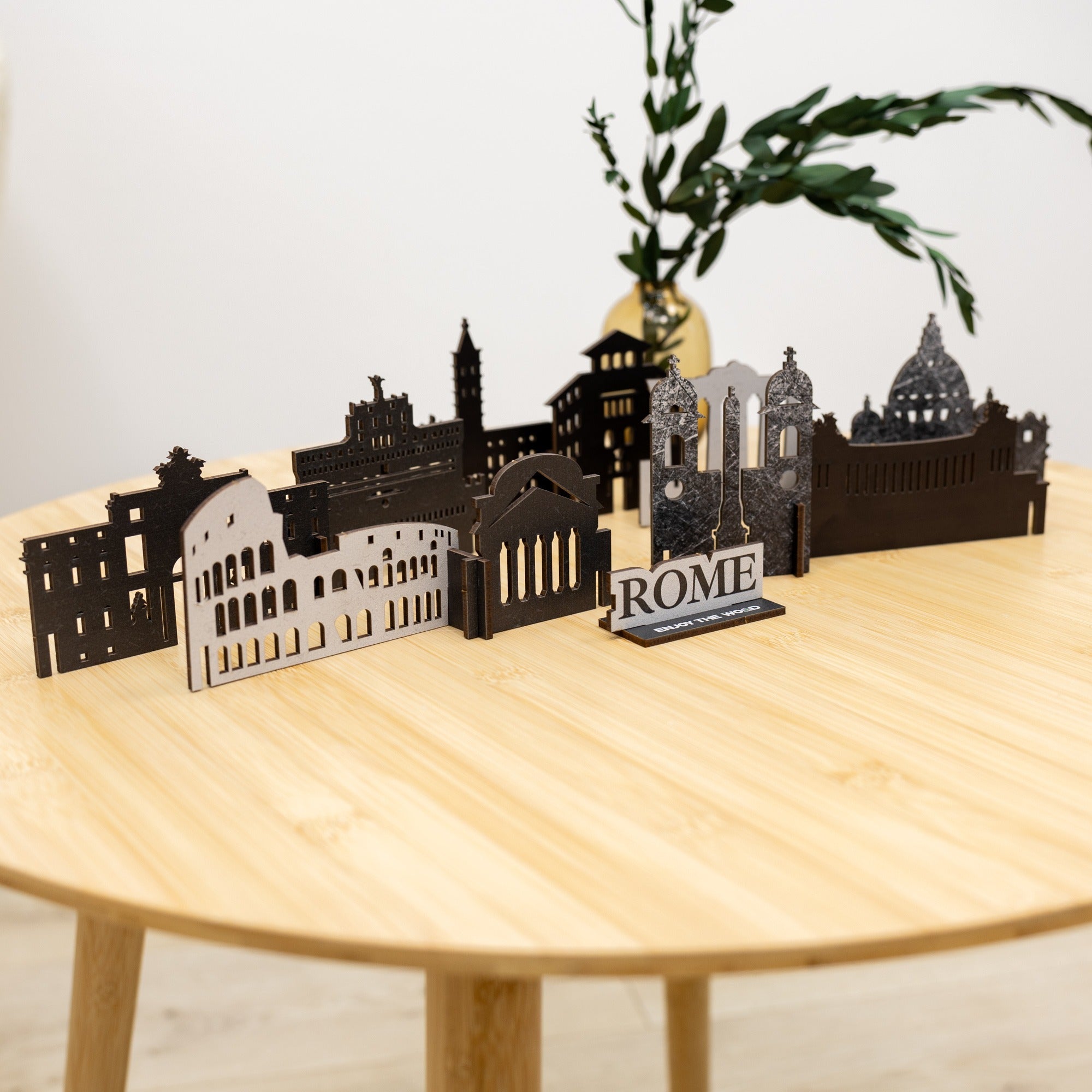 Model of a cityscape with 'Rome' sign on a wooden table