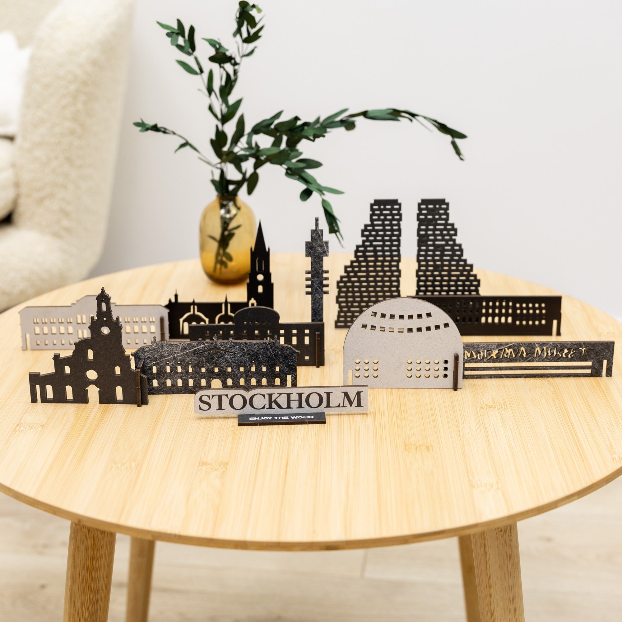 Model of Stockholm landmarks on a wooden table with a plant in the background