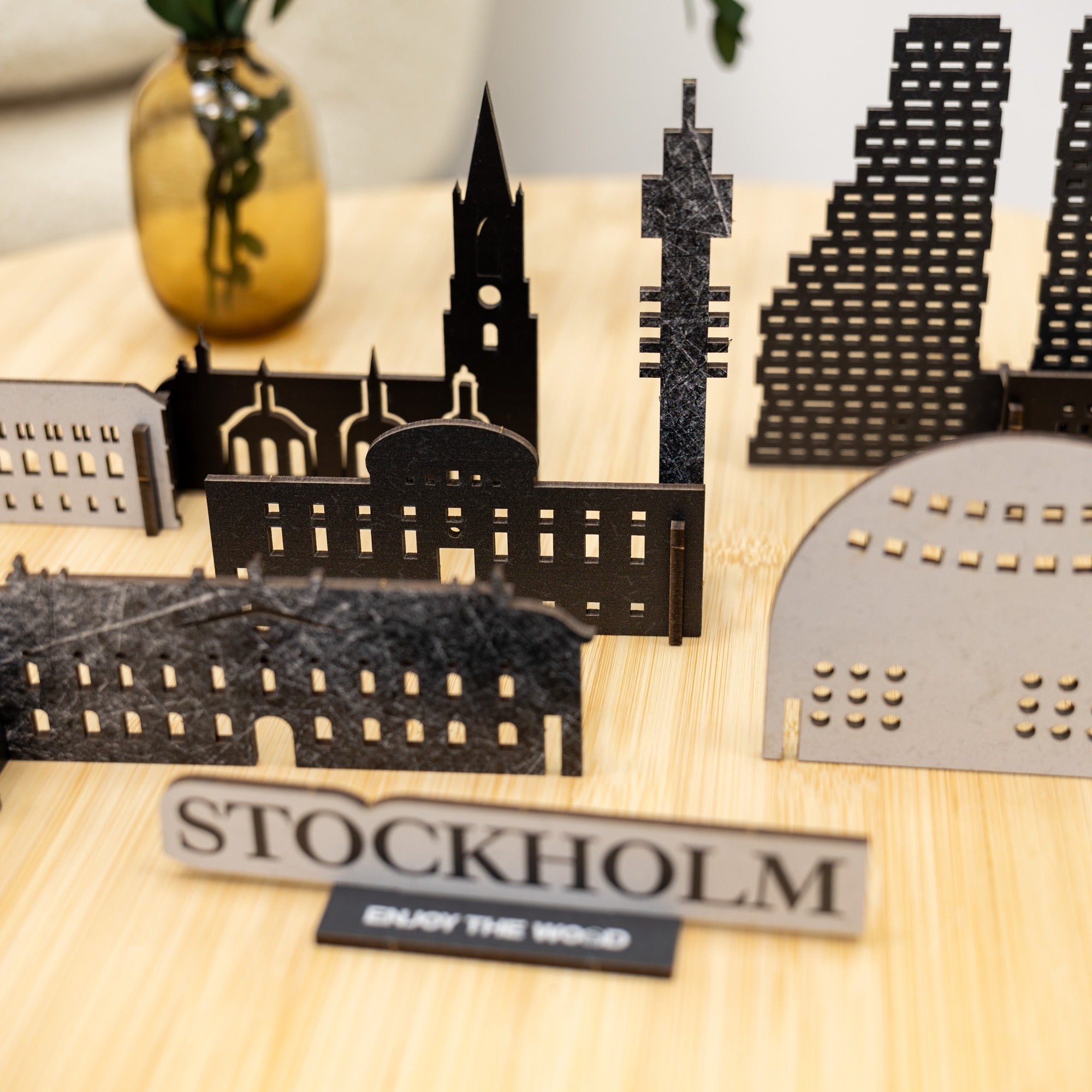 Model of Stockholm's skyline on a wooden surface with 'Stockholm' sign.