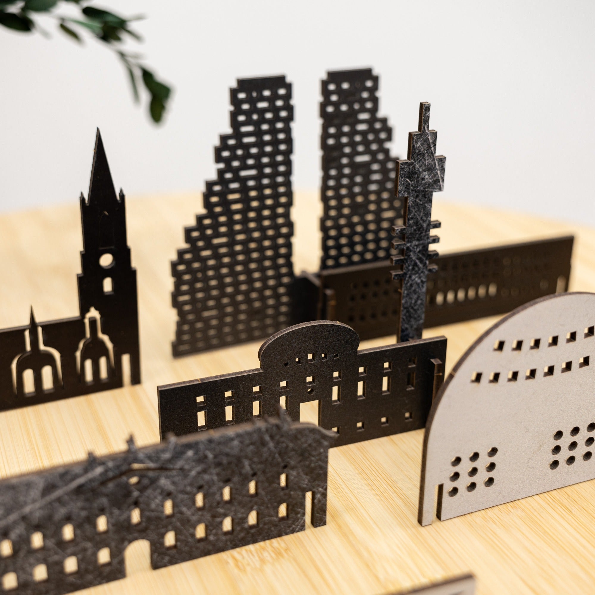 Model of a city skyline with various buildings on a wooden surface