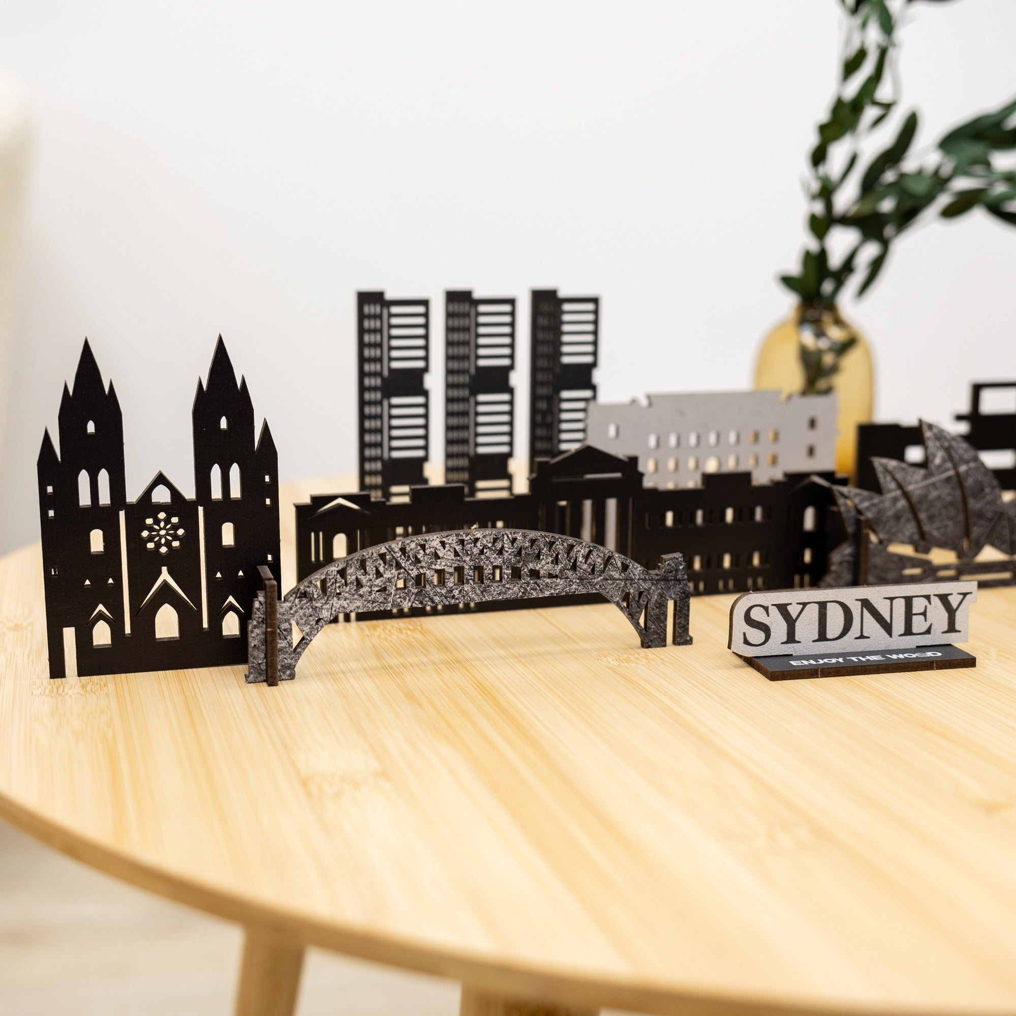 Model of Sydney skyline on a wooden table with a plant in the background