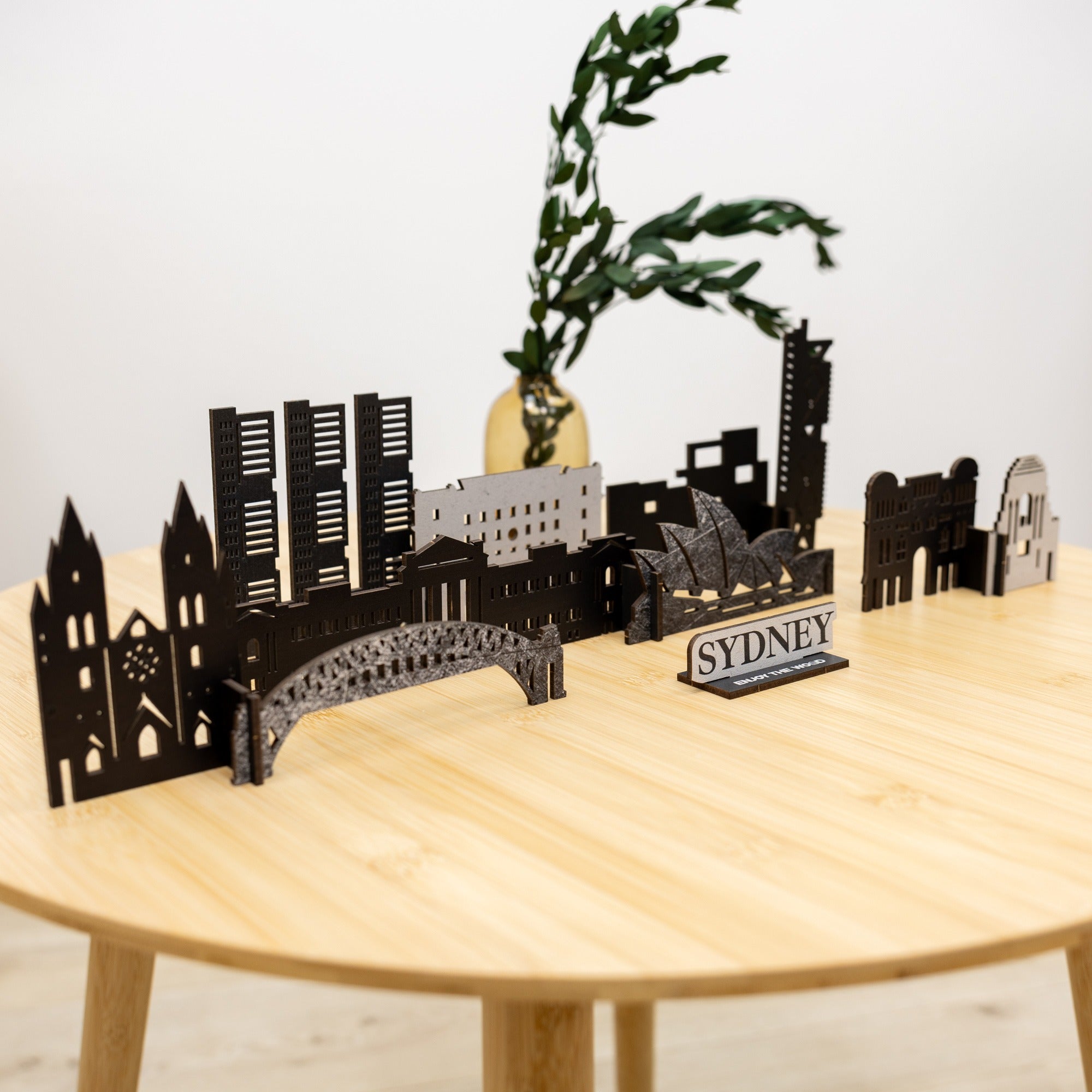 Sydney skyline model on a wooden table with a plant in the background