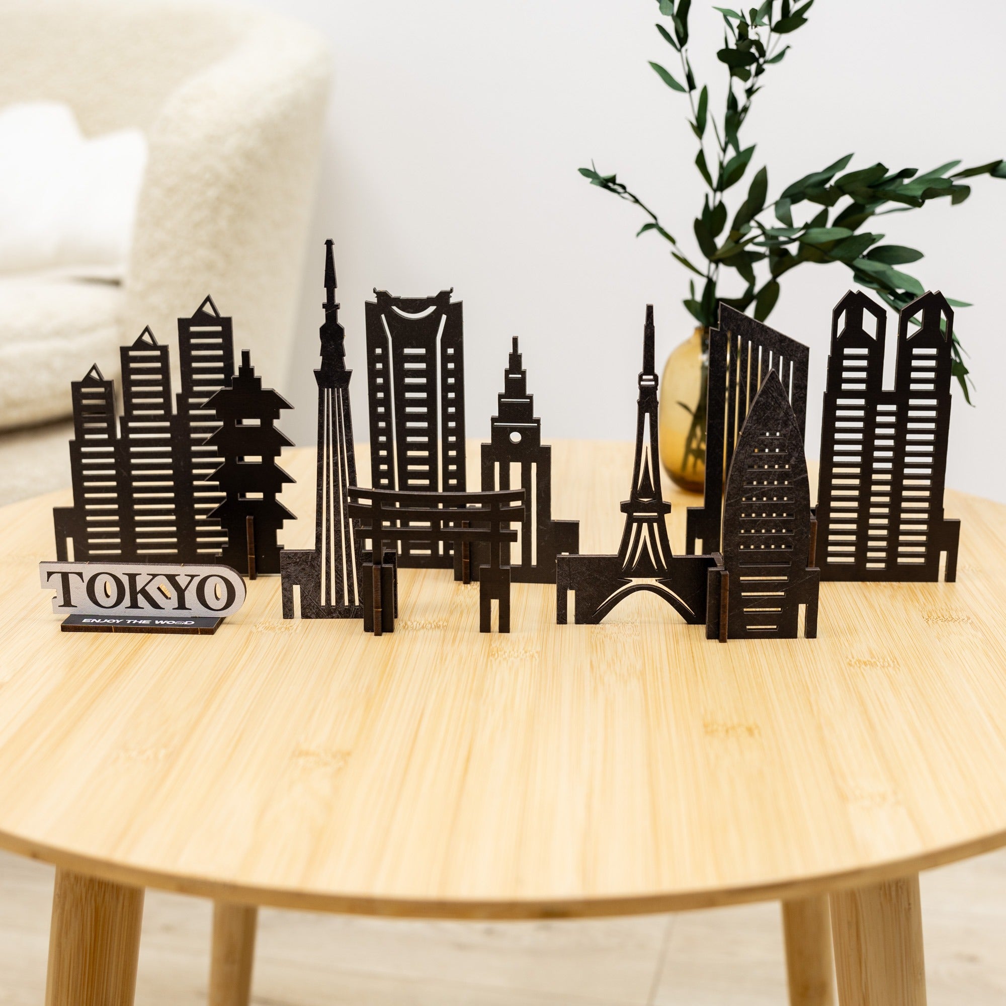 Model of Tokyo skyline on a wooden table with a plant in the background