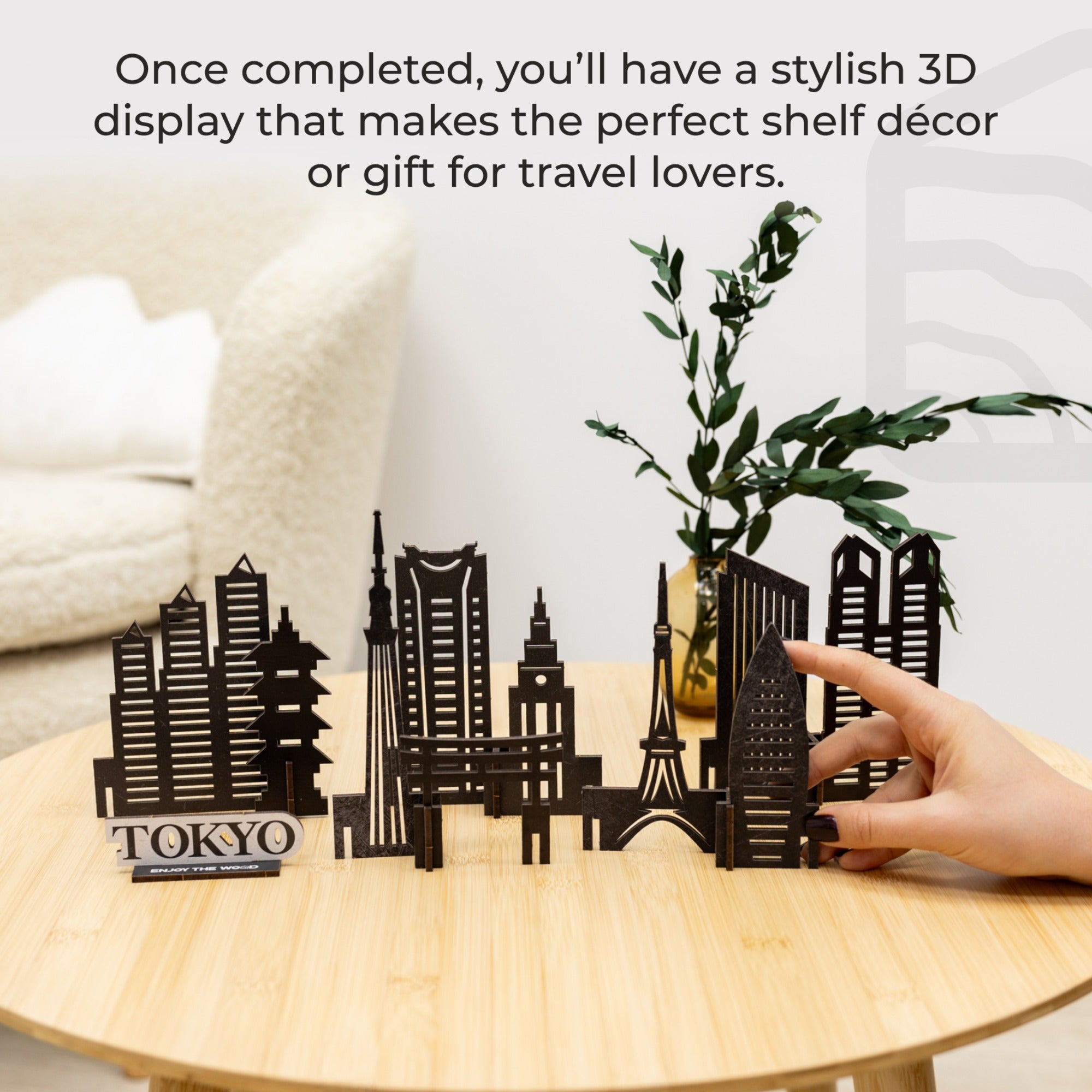 3D cityscape model on a table with text about shelf decor and travel gifts.