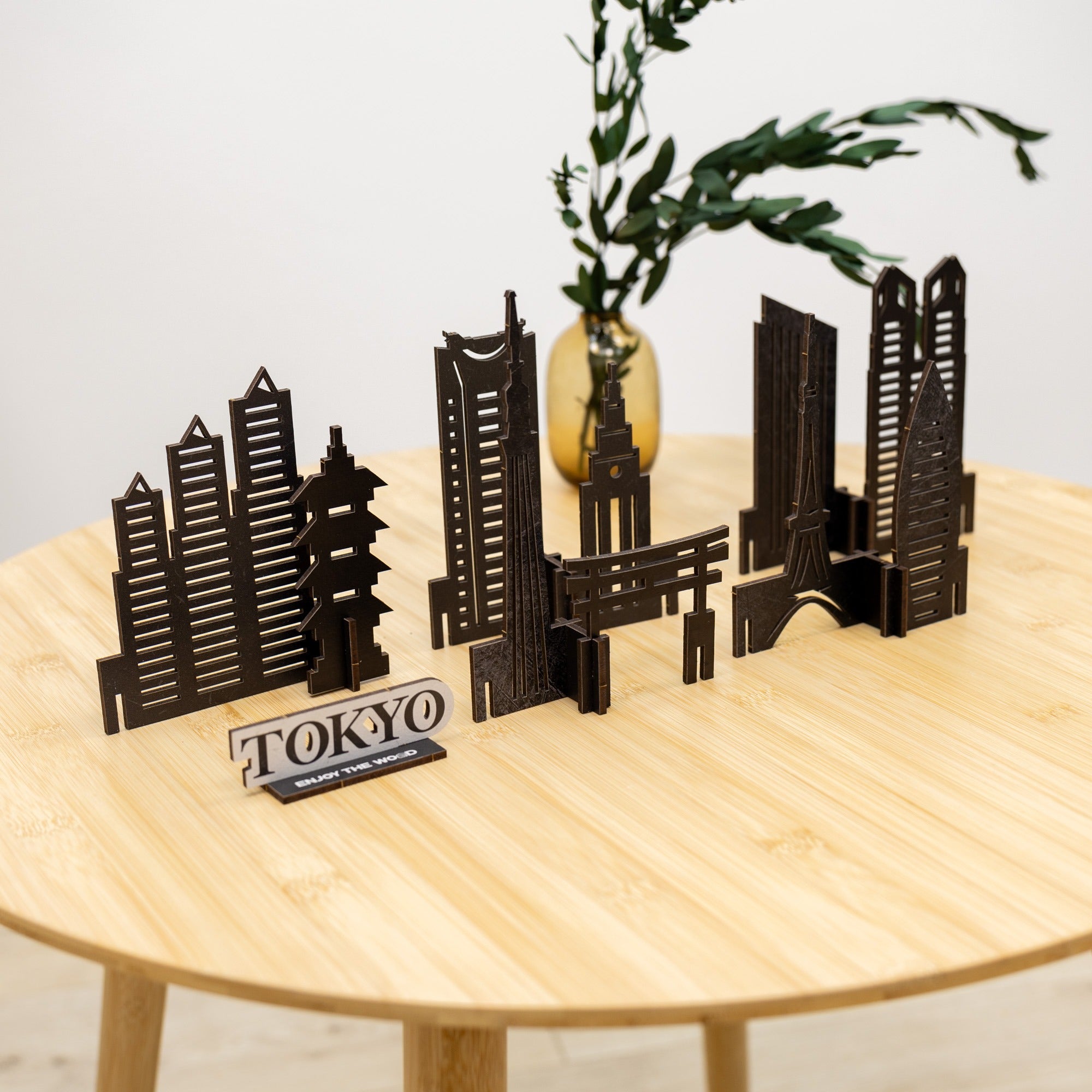 Model of Tokyo skyline on a wooden table with a plant in the background