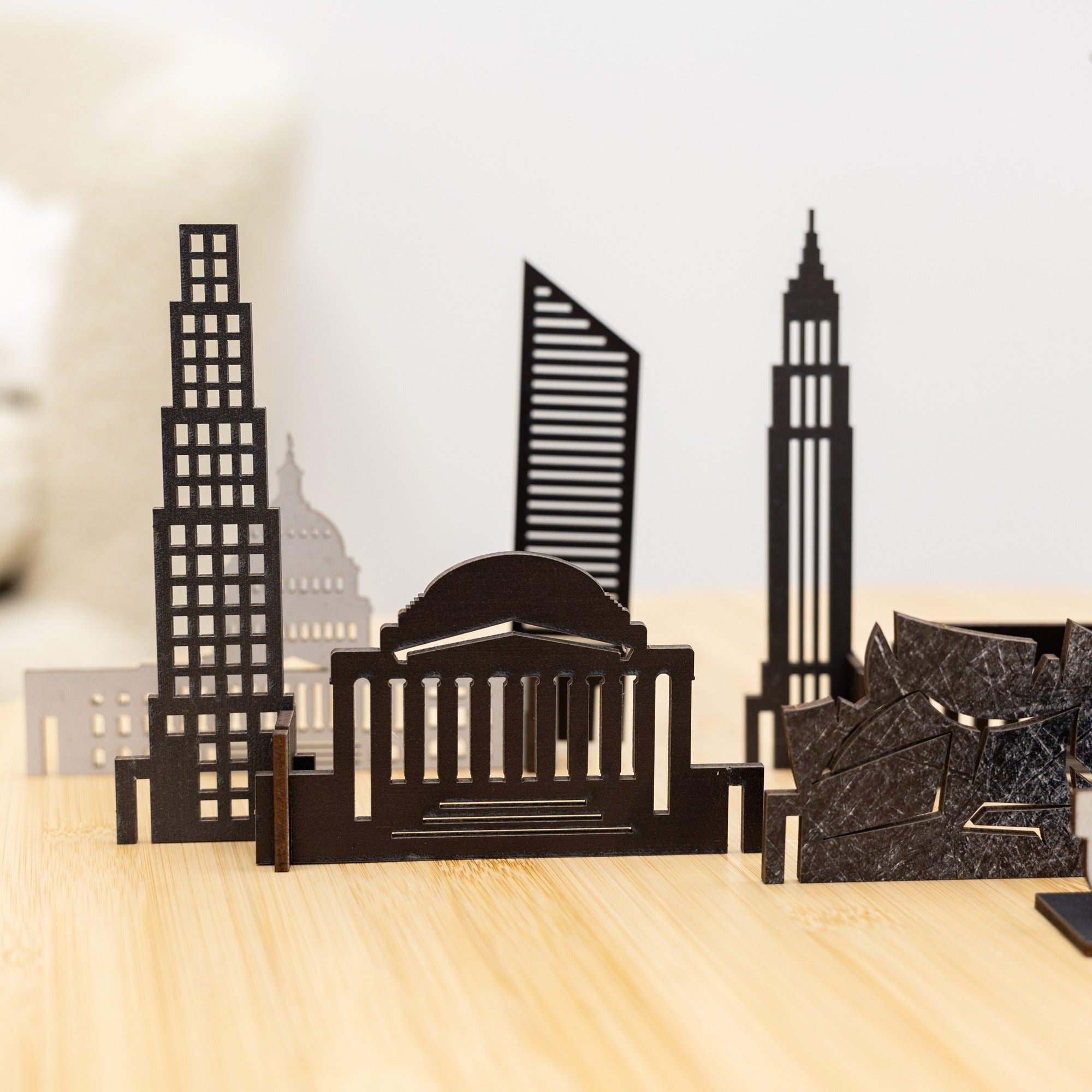 Model of a city skyline with tall buildings on a wooden surface
