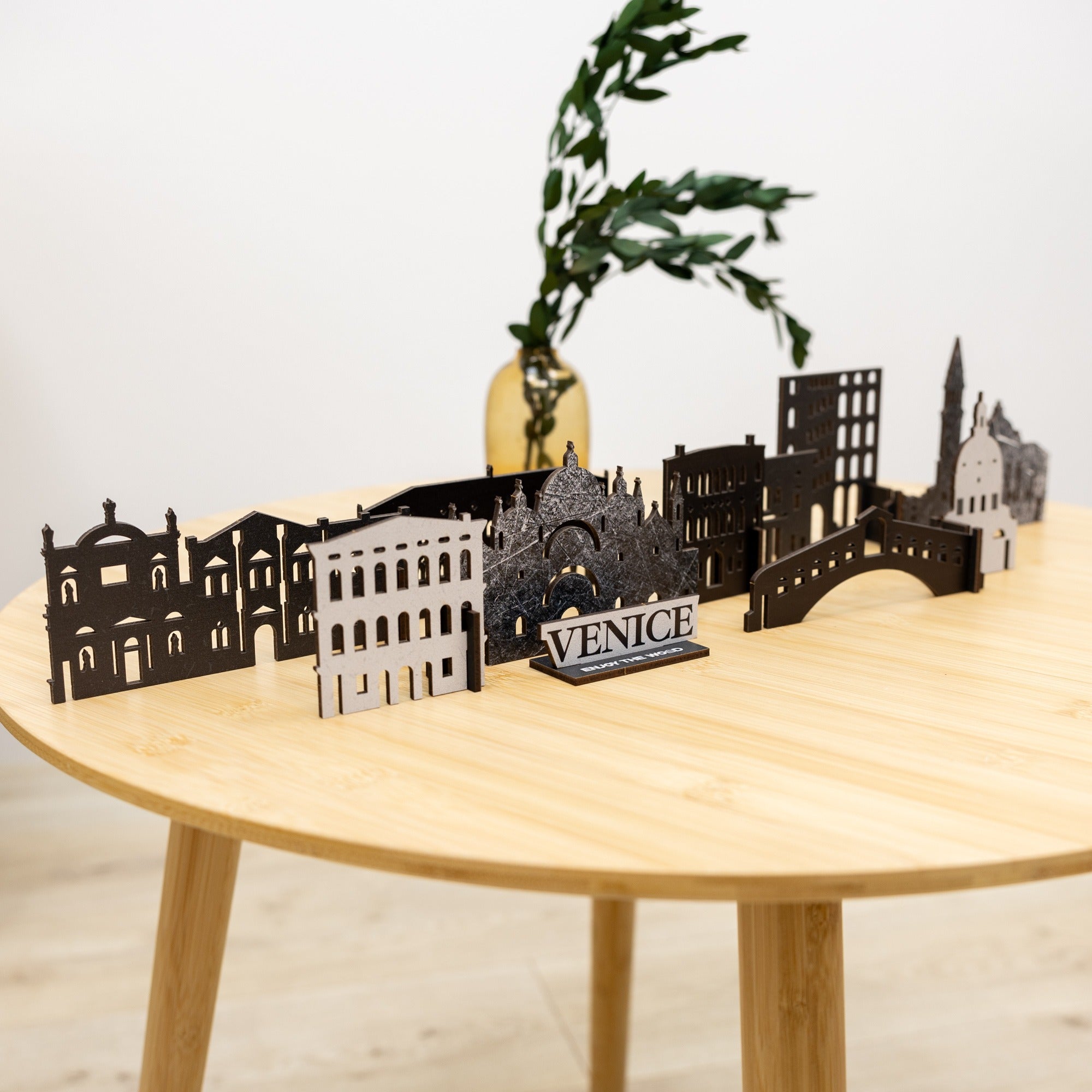 Model of Venice skyline on a wooden table with a plant in the background