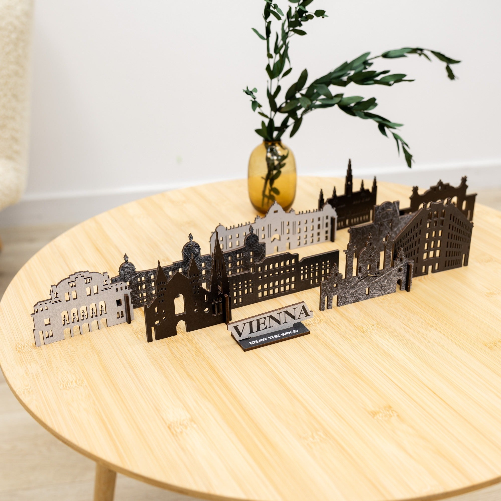 Model of Vienna's skyline on a wooden table with a plant in the background